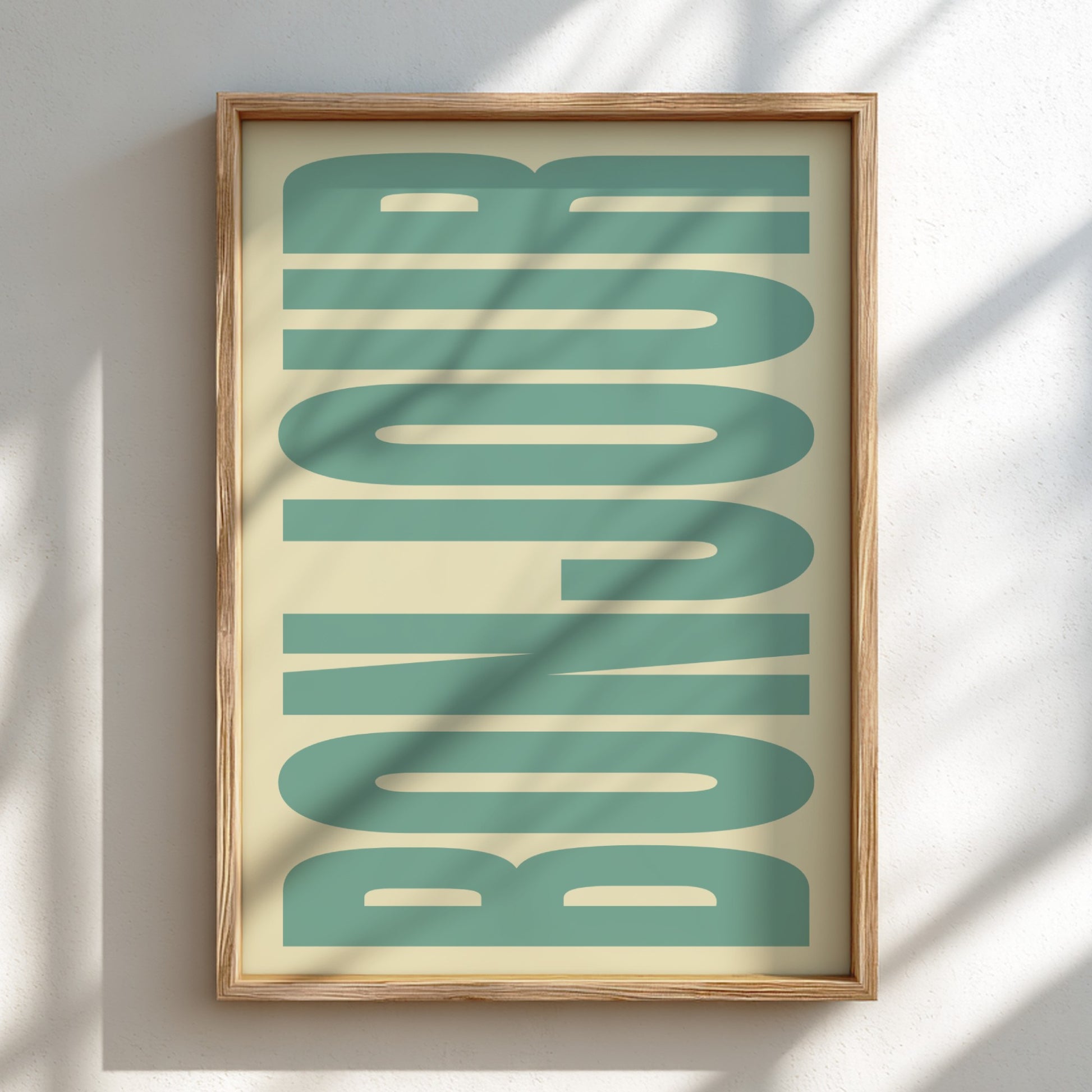 Framed artwork with 'BONJOUR' text in teal on a beige background