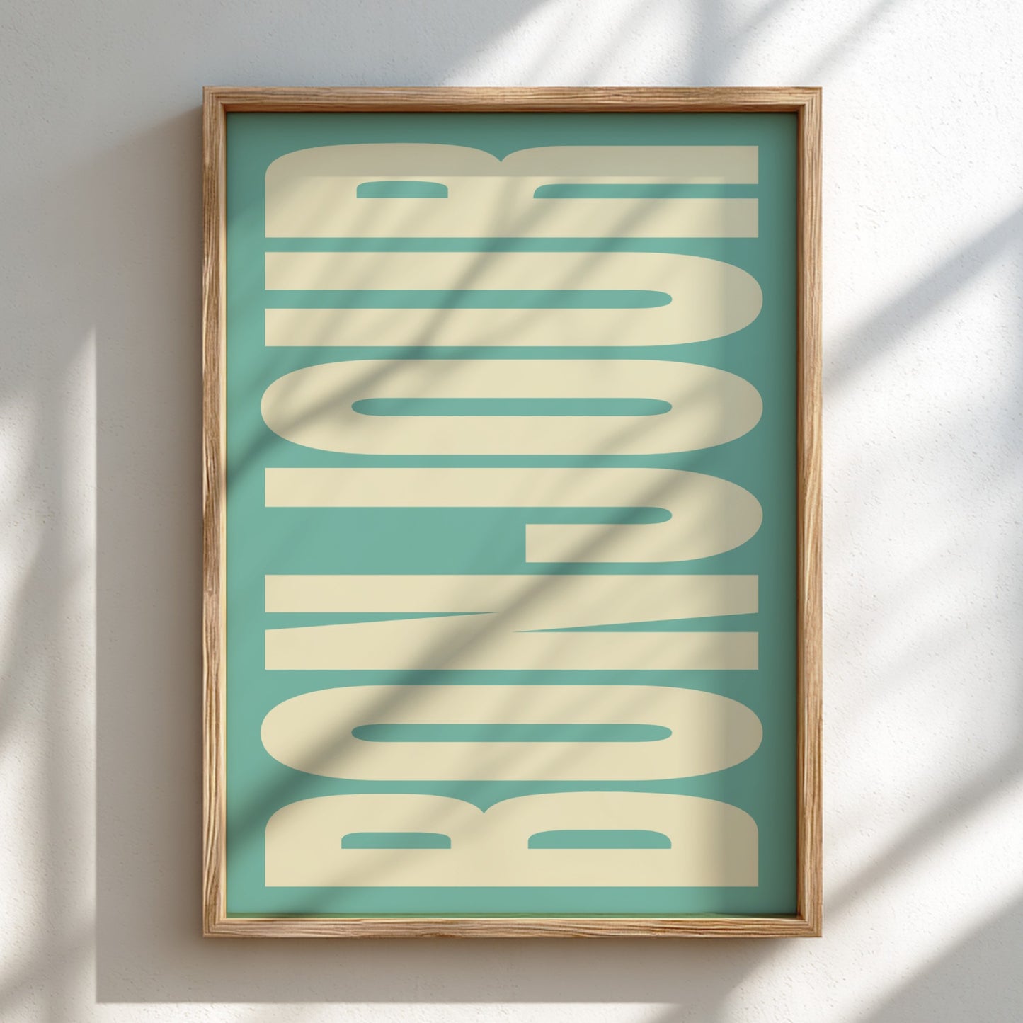 Framed artwork with 'BONJOUR' text on a teal background