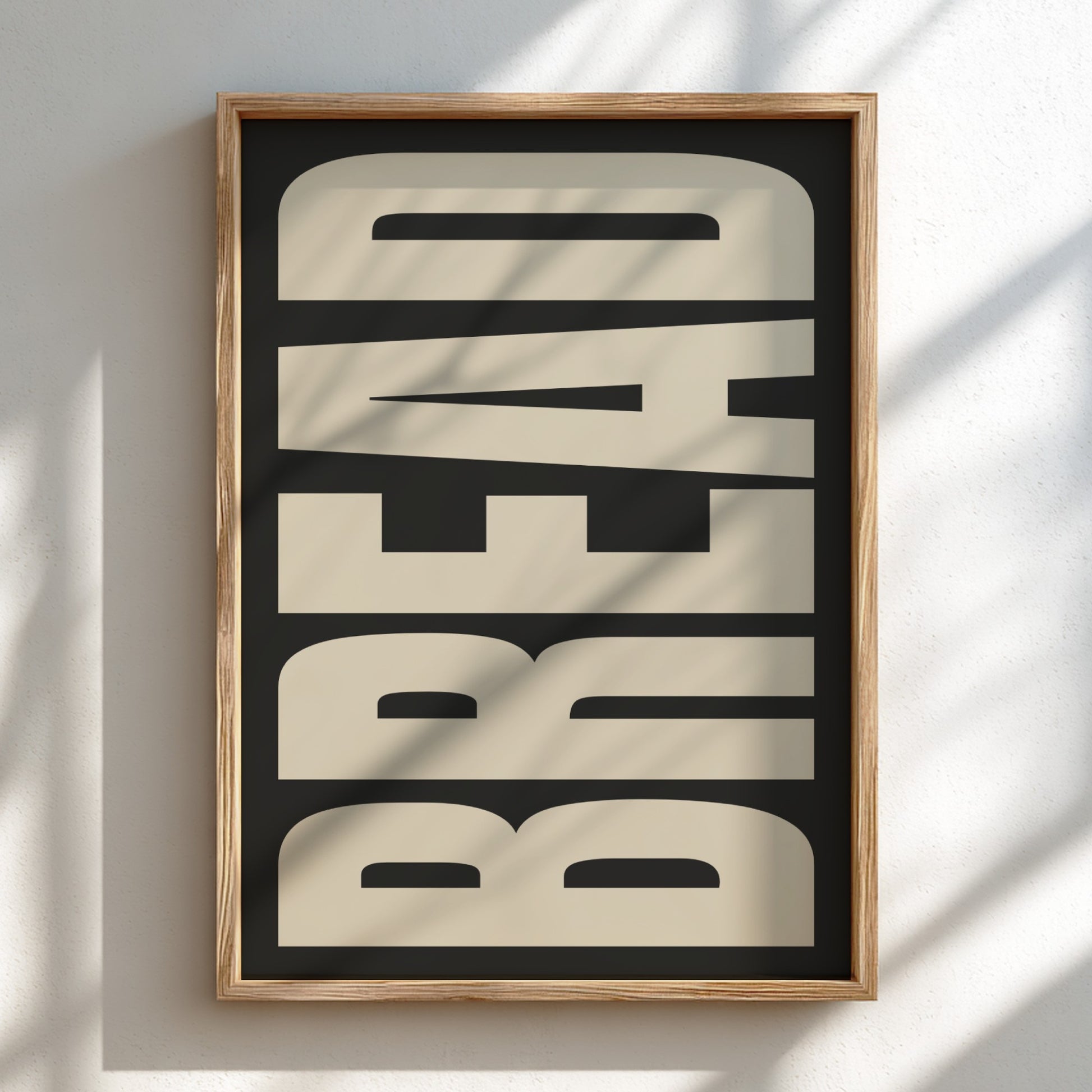 Framed artwork with 'BREAD' text on a black background