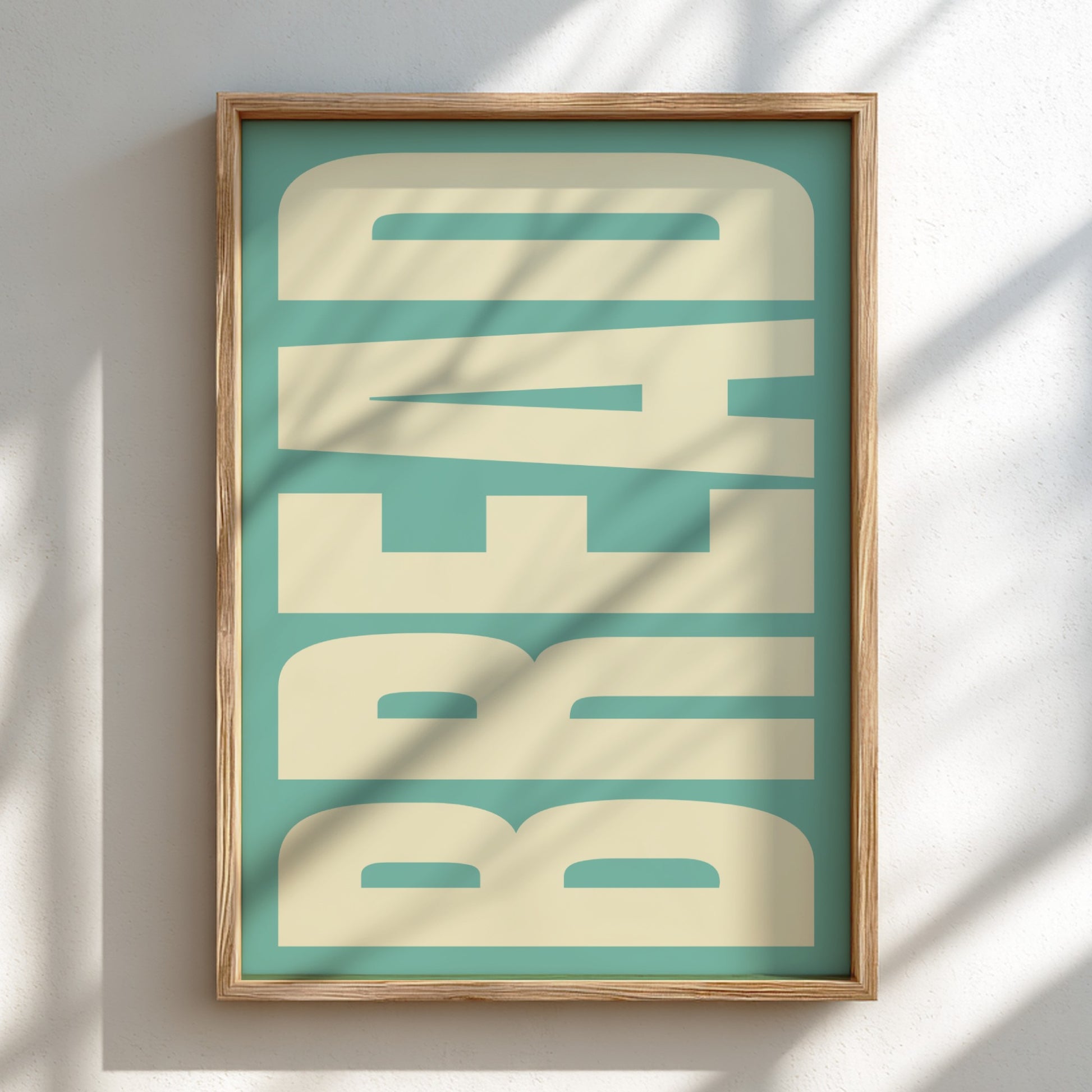 Framed artwork with 'BREAD' text on a teal background