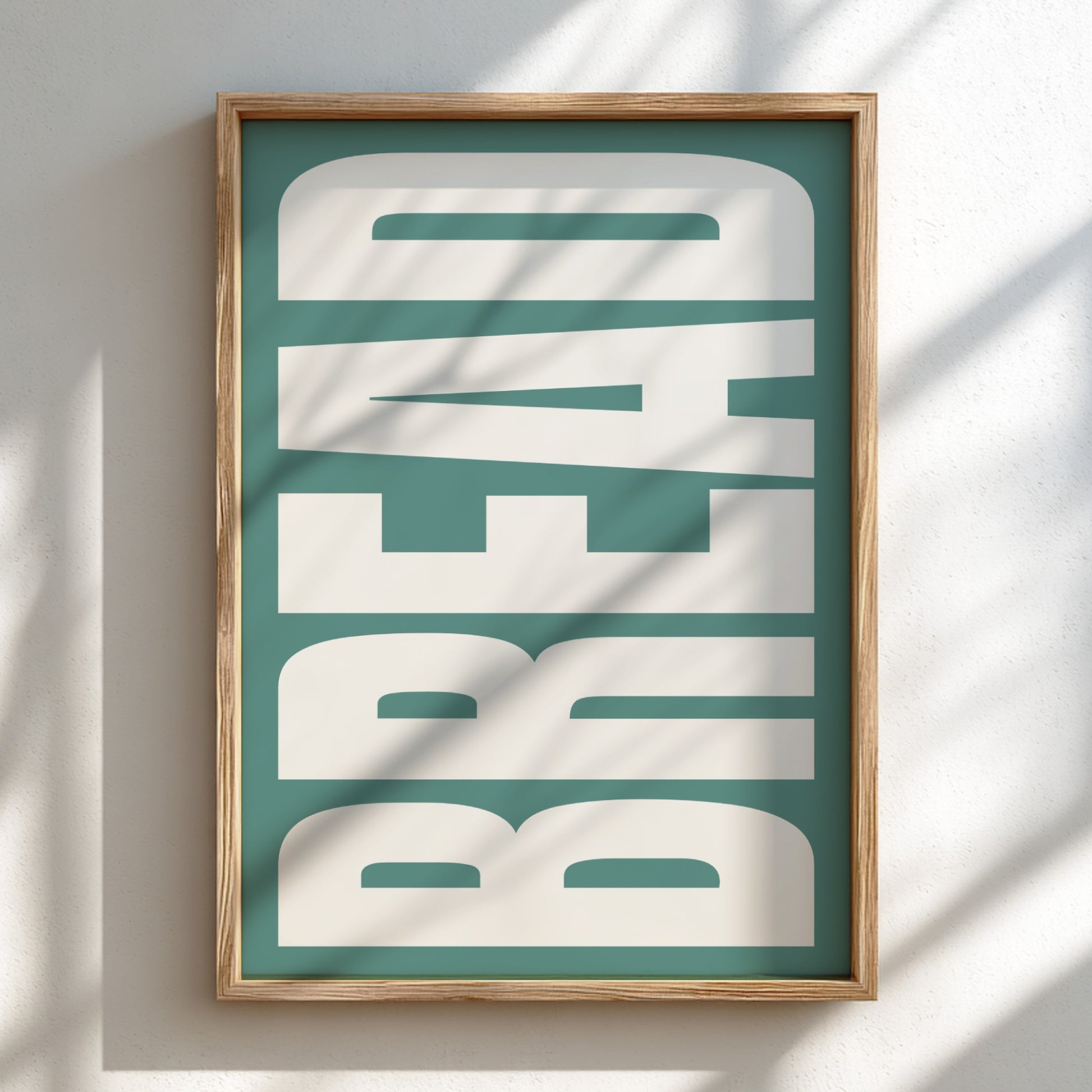 Framed artwork with 'BREAD' text on a teal background