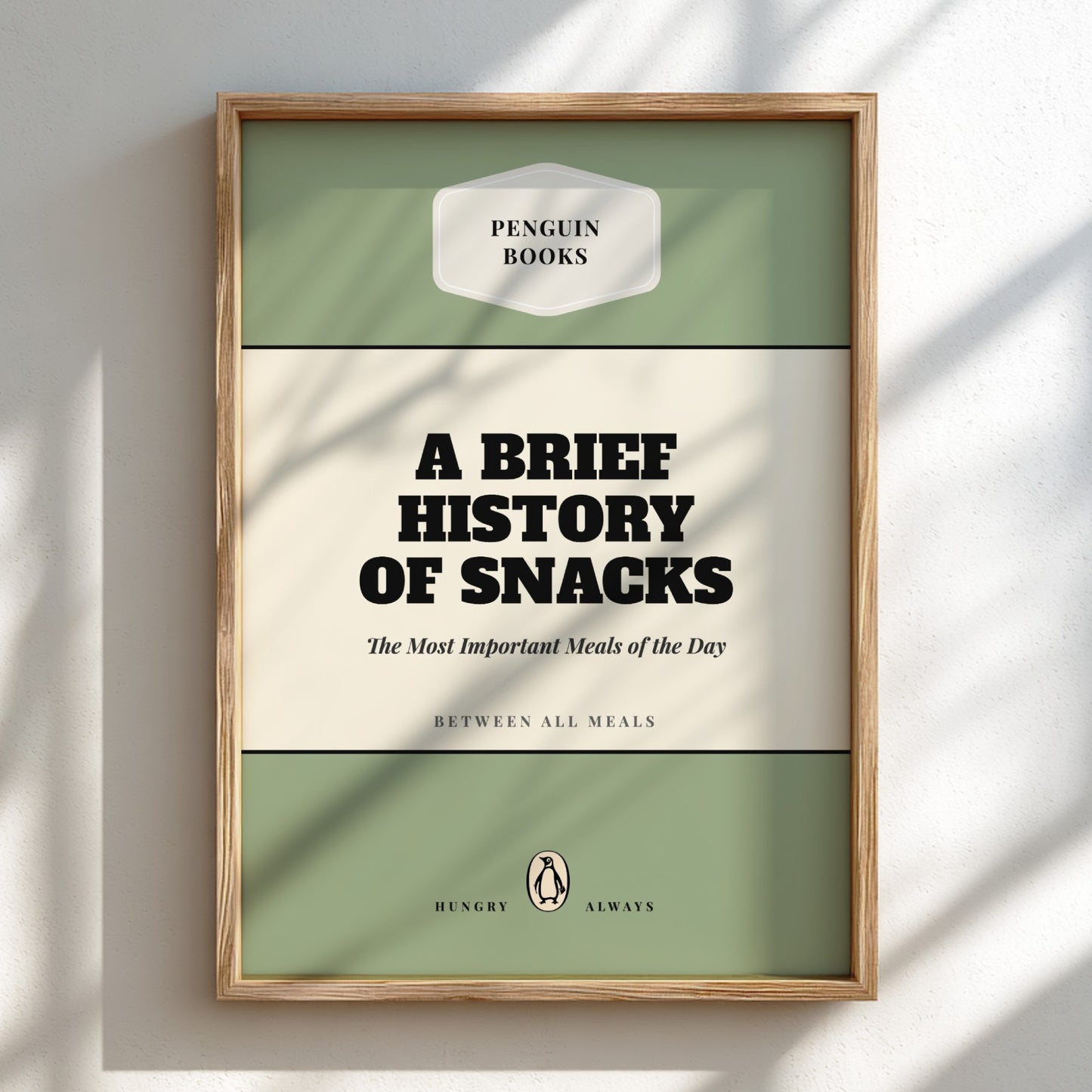 Framed book cover of 'A Brief History of Snacks' by Penguin Books on a light background