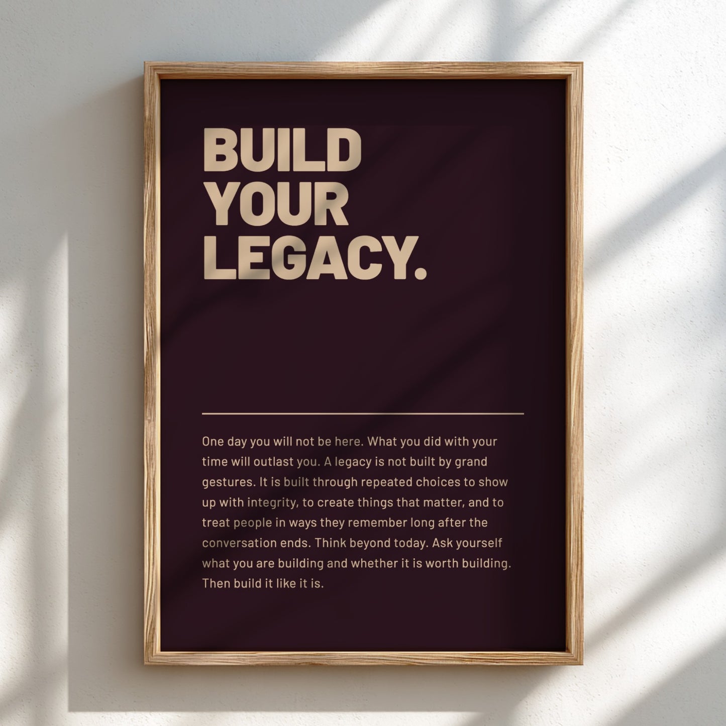 Framed poster with motivational quote 'Build Your Legacy' on a dark background