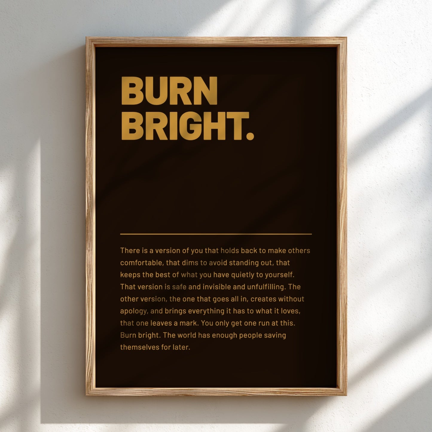 Framed poster with 'BURN BRIGHT.' text on a dark background