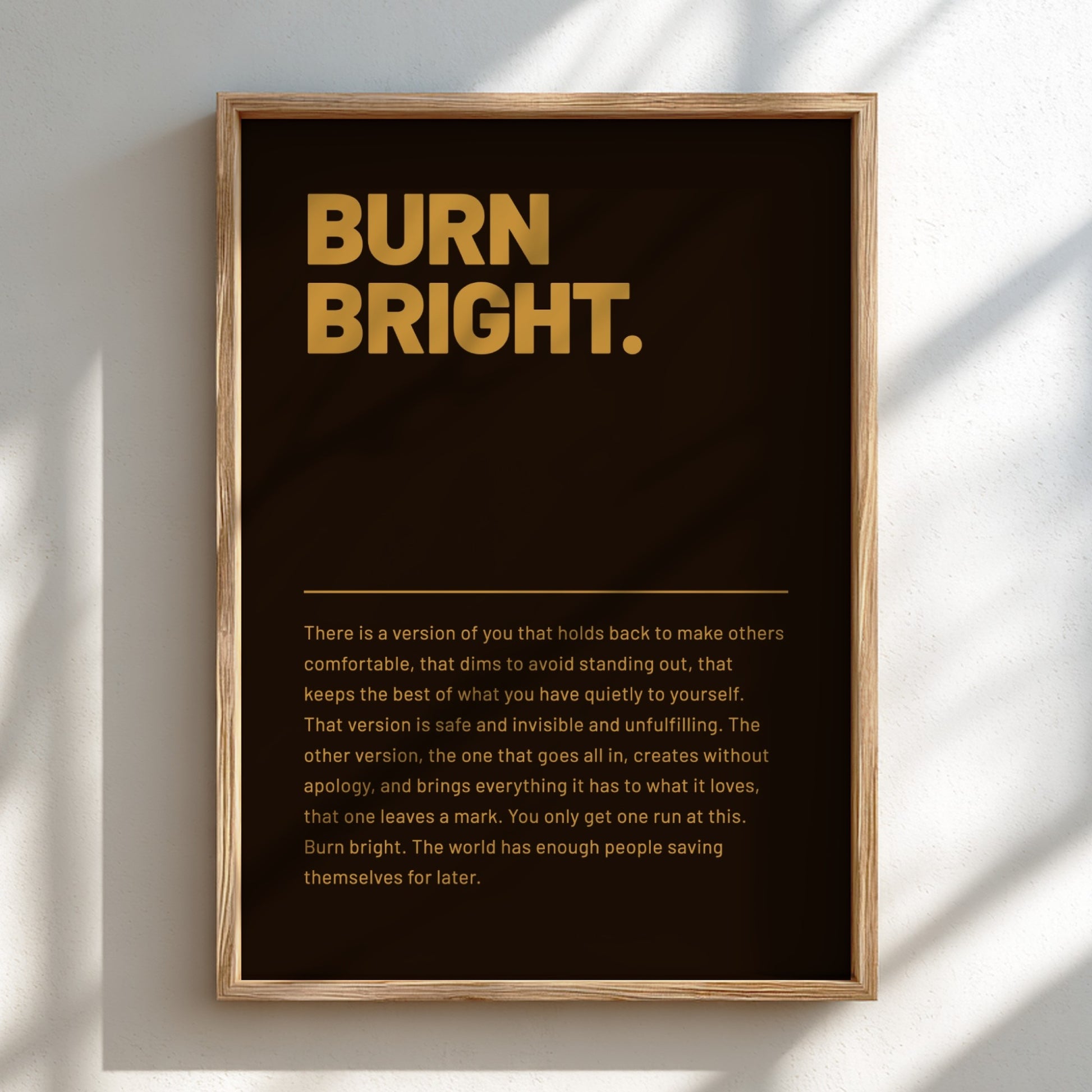 Framed poster with 'BURN BRIGHT.' text on a dark background