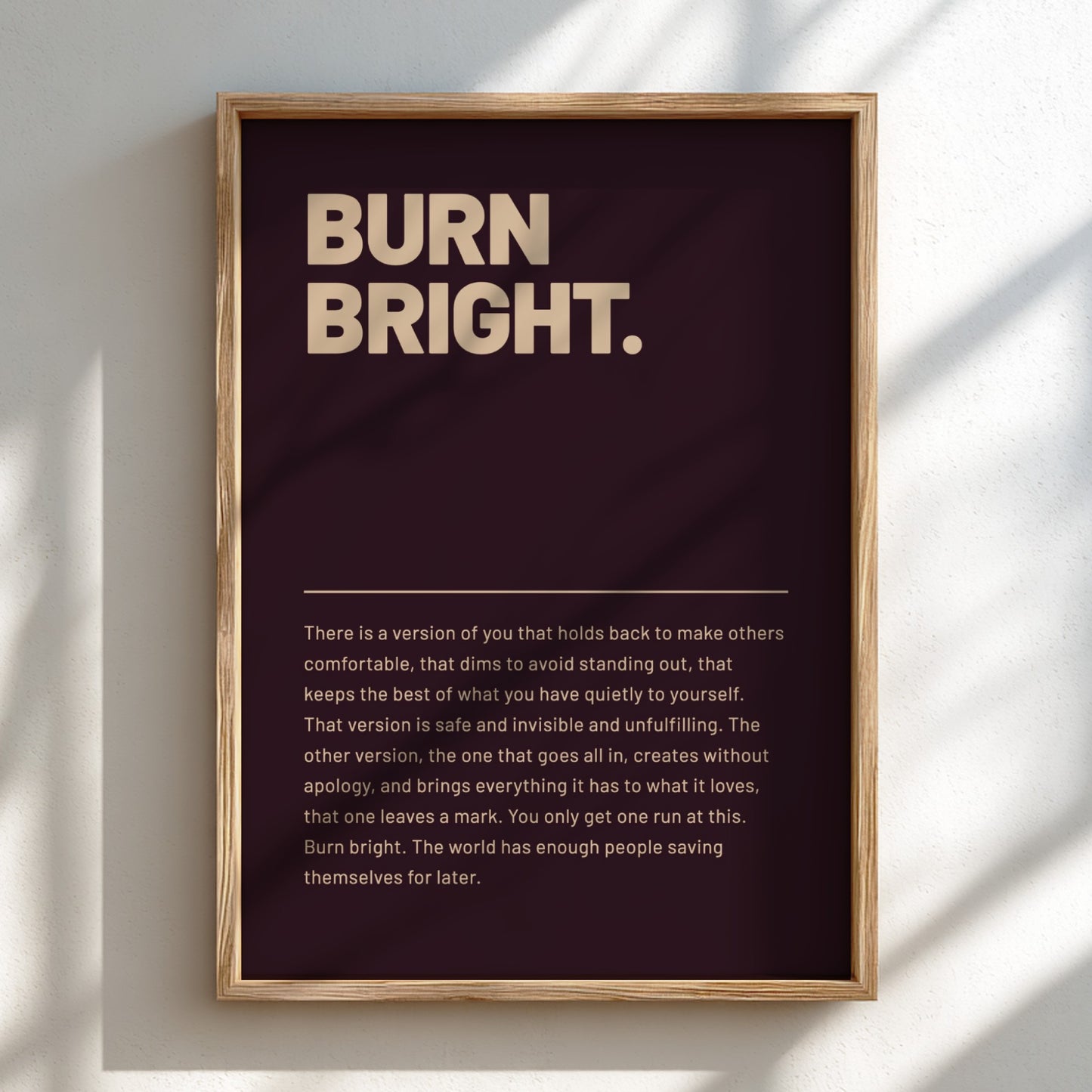 Framed poster with motivational quote 'BURN BRIGHT.' on a dark background