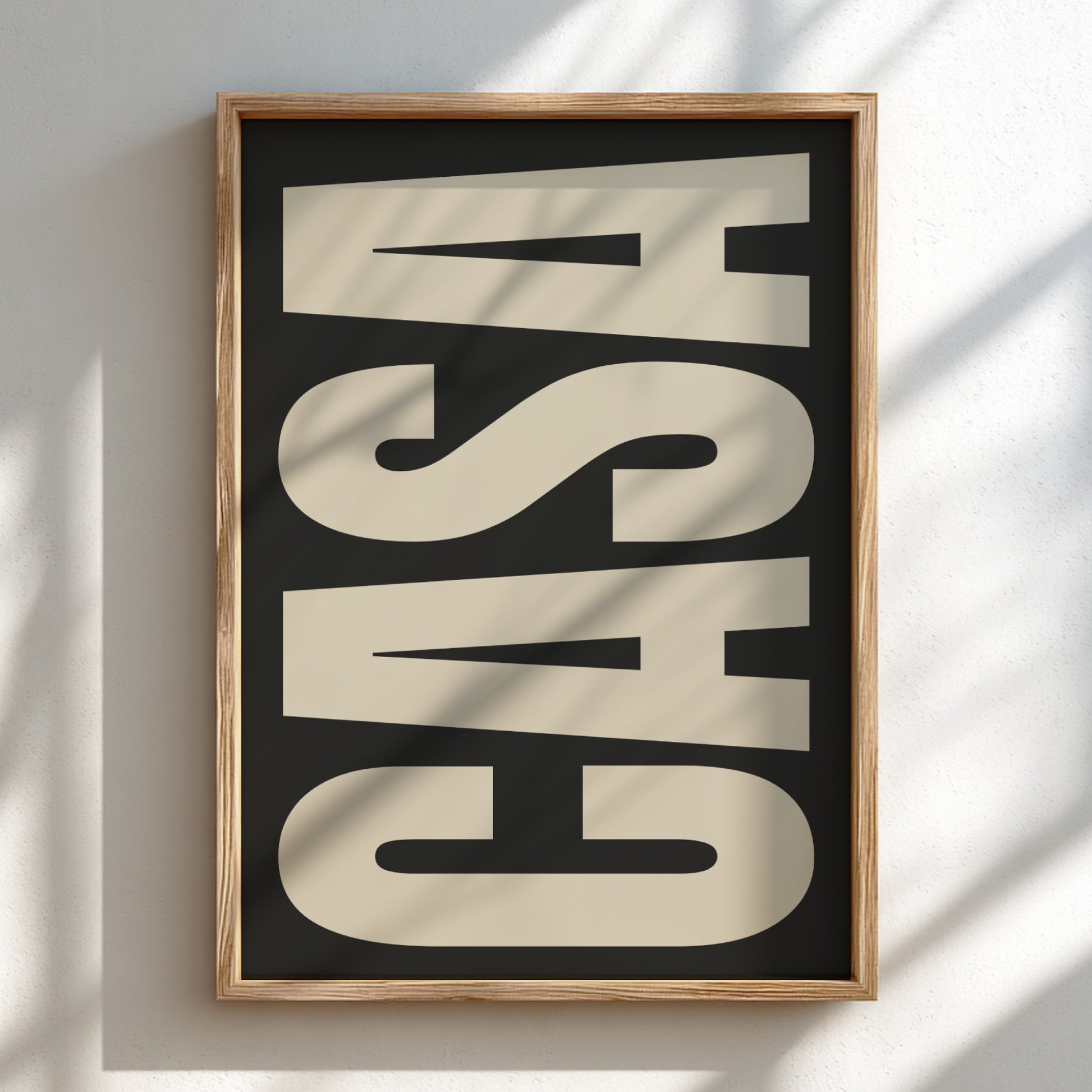 Framed artwork with the word 'CASA' on a black background