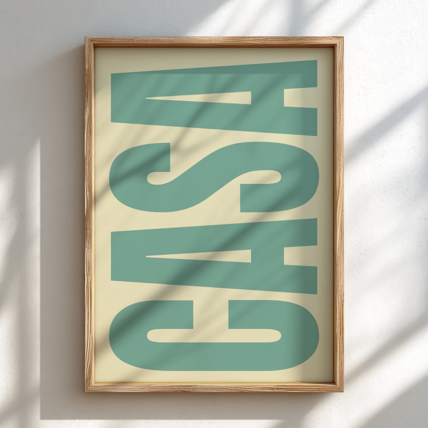 Framed artwork with large green letters on a beige background