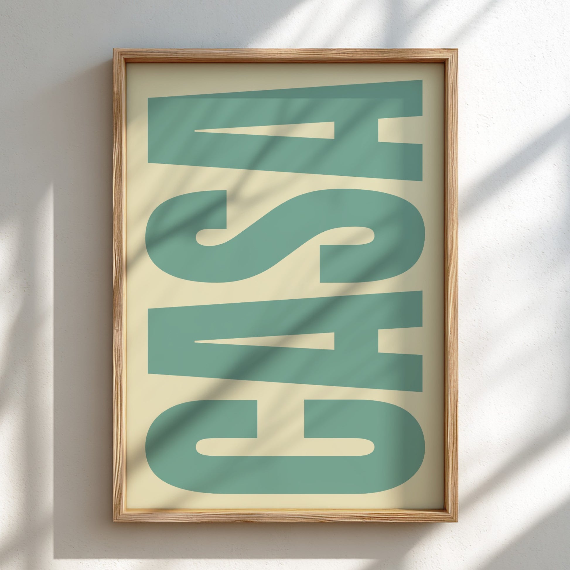 Framed artwork with large green letters on a beige background