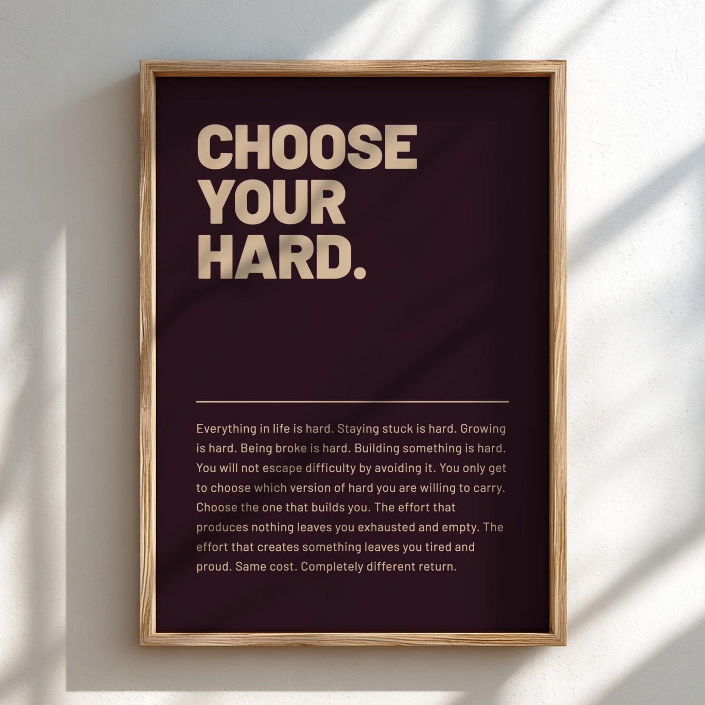 Framed poster with motivational quote 'CHOOSE YOUR HARD.' on a dark background