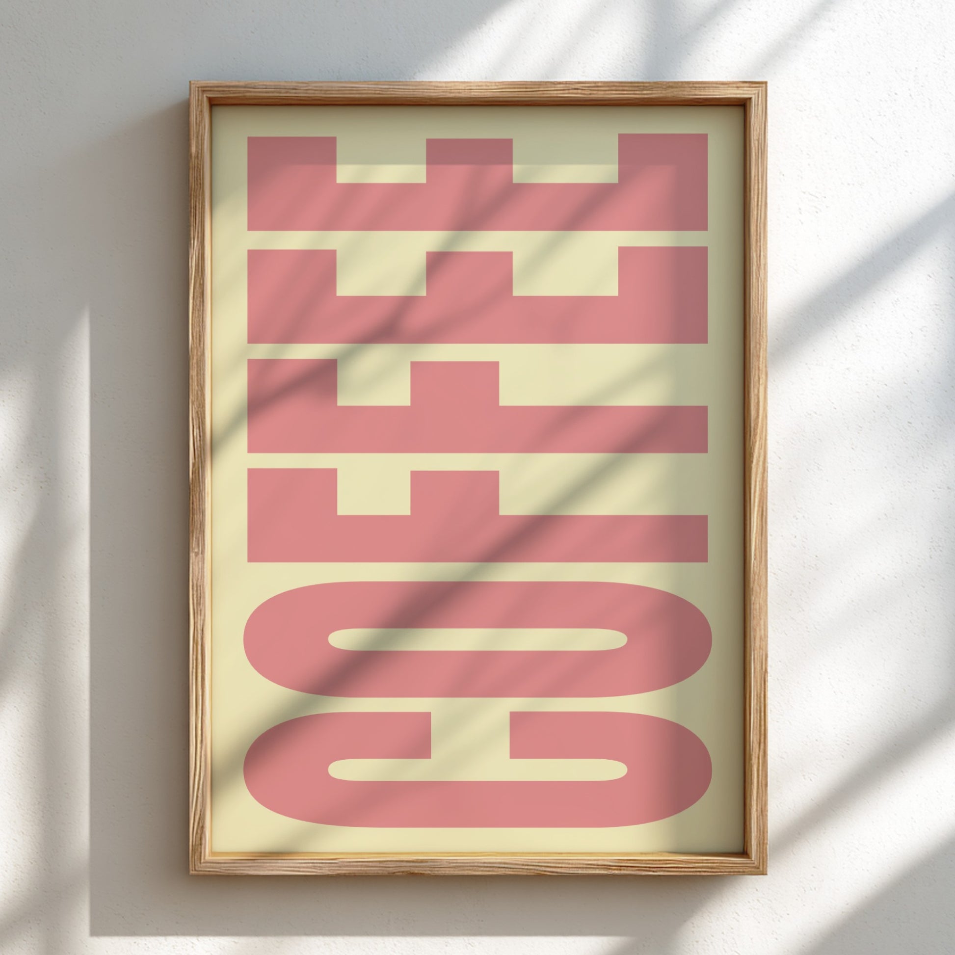 Framed artwork with 'COFFEE' in pink on a light background