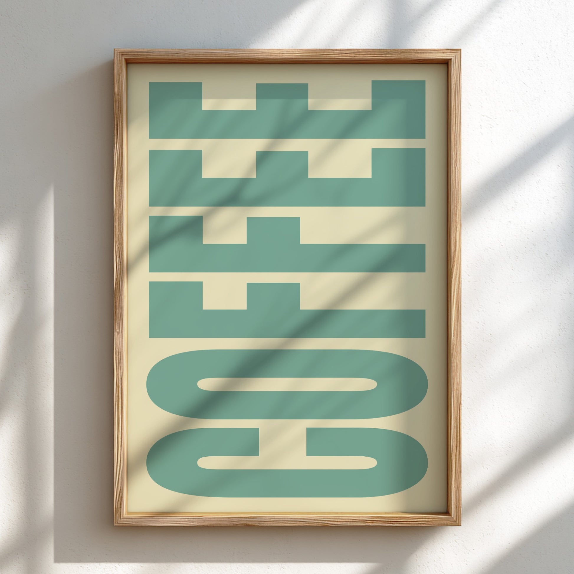 Framed artwork with 'COFFEE' text in a geometric style on a light background
