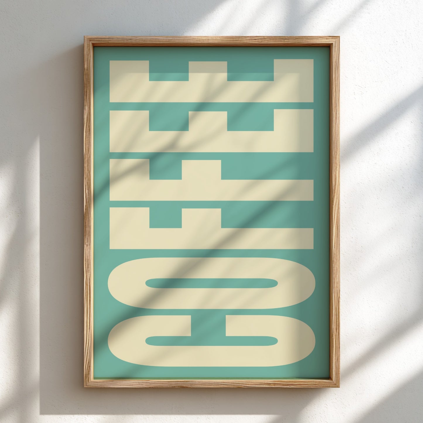 Framed artwork with 'COFFEE' text on a teal background