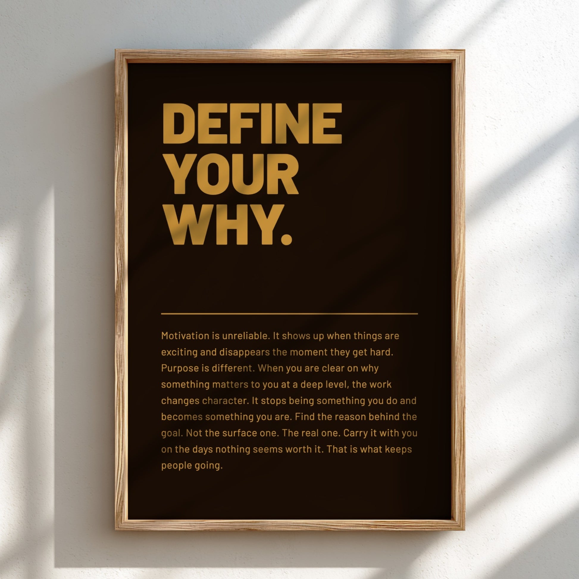 Framed poster with 'Define Your Why' text on a black background