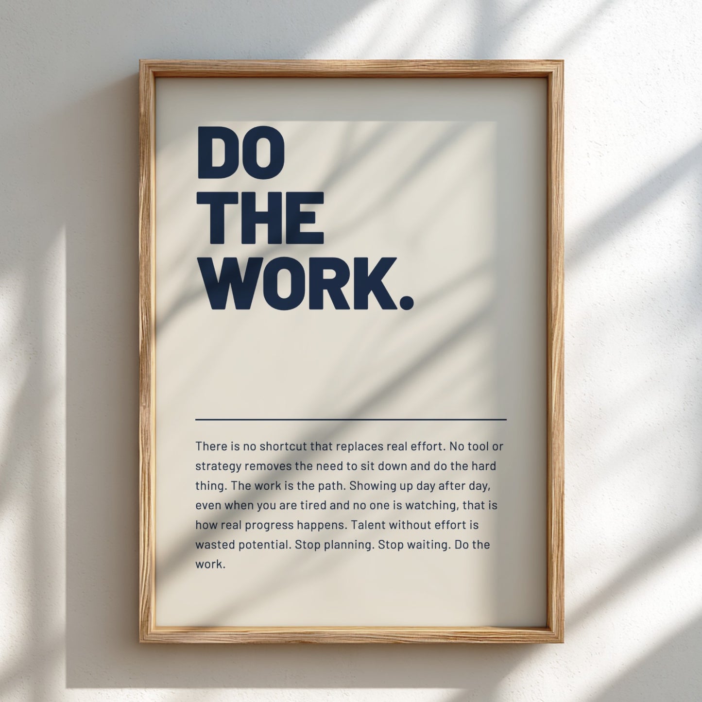 Framed poster with motivational quote 'DO THE WORK' on a light background