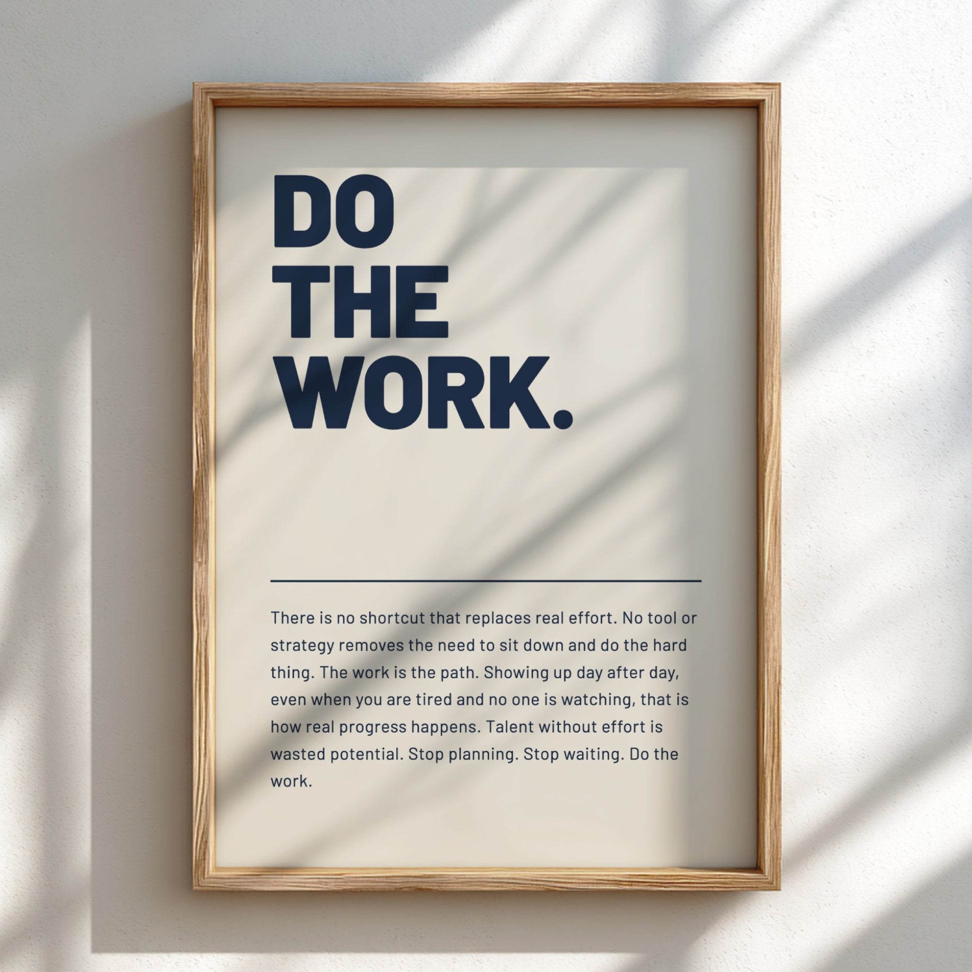 Framed poster with motivational quote 'DO THE WORK' on a light background