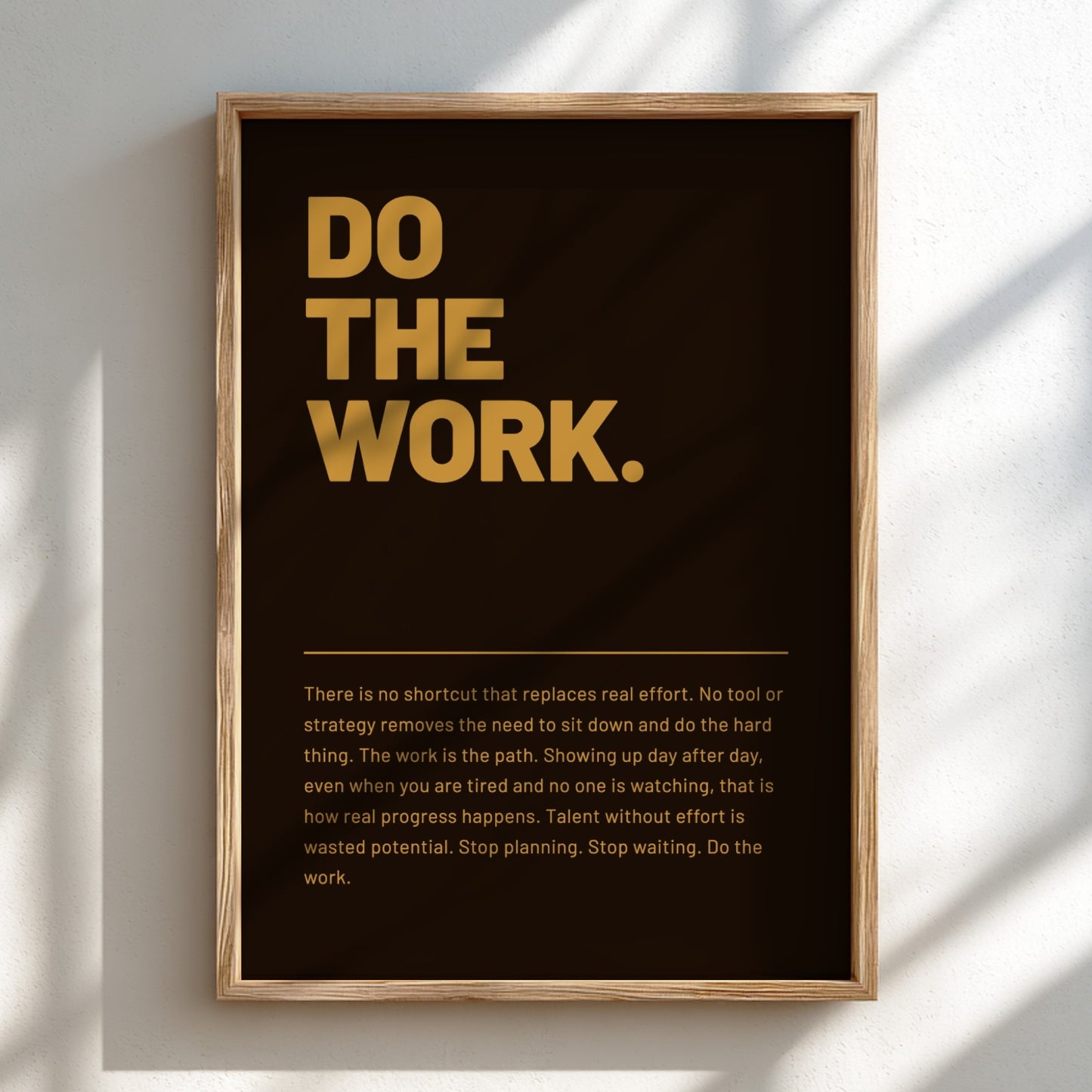 Framed poster with motivational quote 'DO THE WORK.' on a dark background