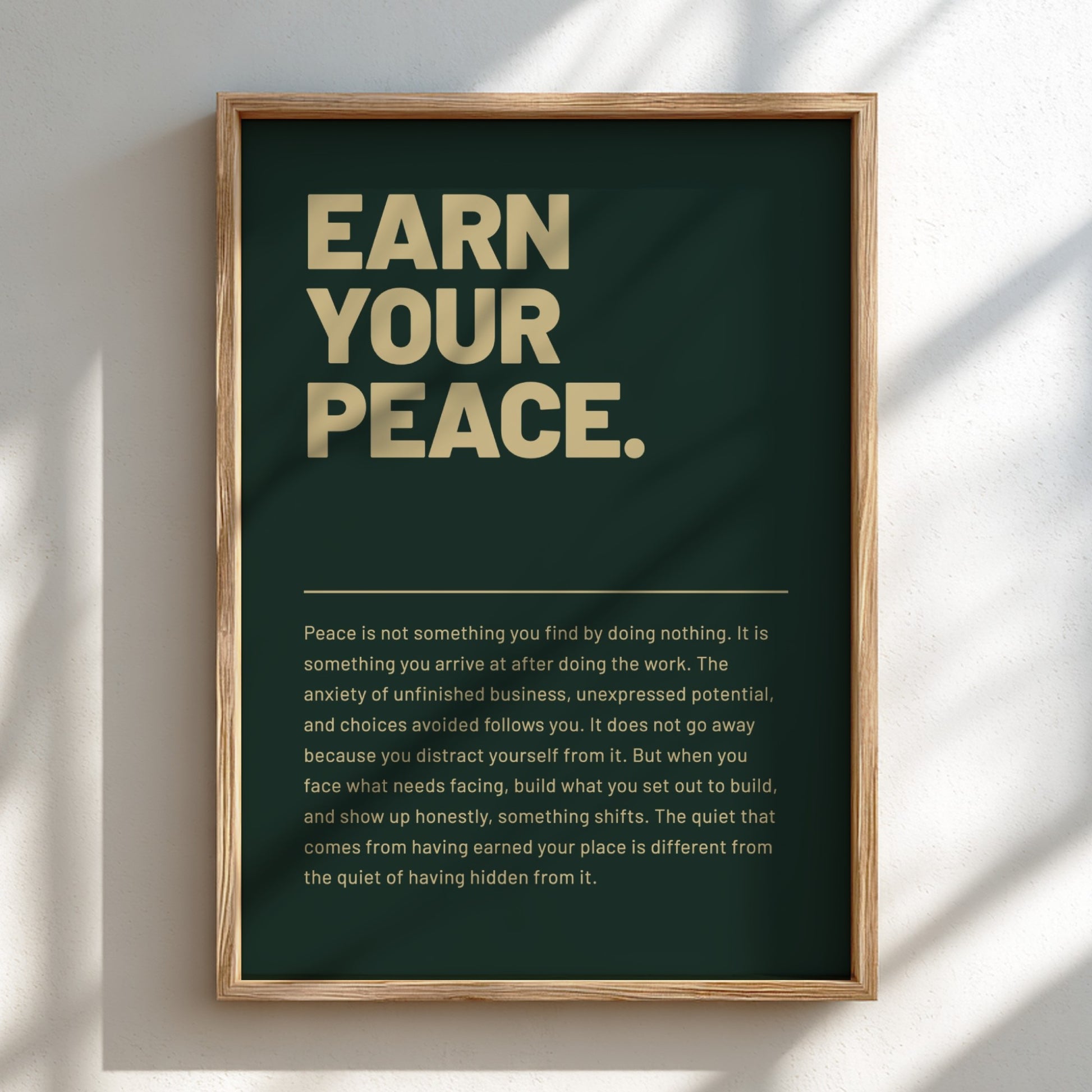 Framed poster with motivational quote 'Earn Your Peace' on a dark background