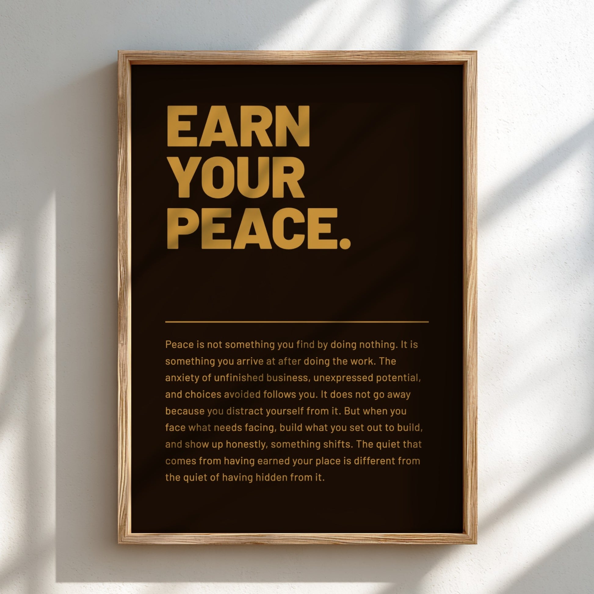 Framed poster with 'Earn Your Peace' text on a dark background