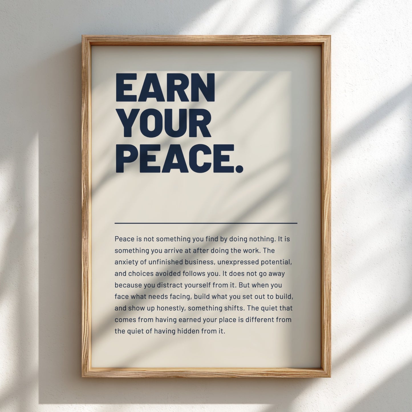 Framed poster with 'Earn Your Peace' text on a light background