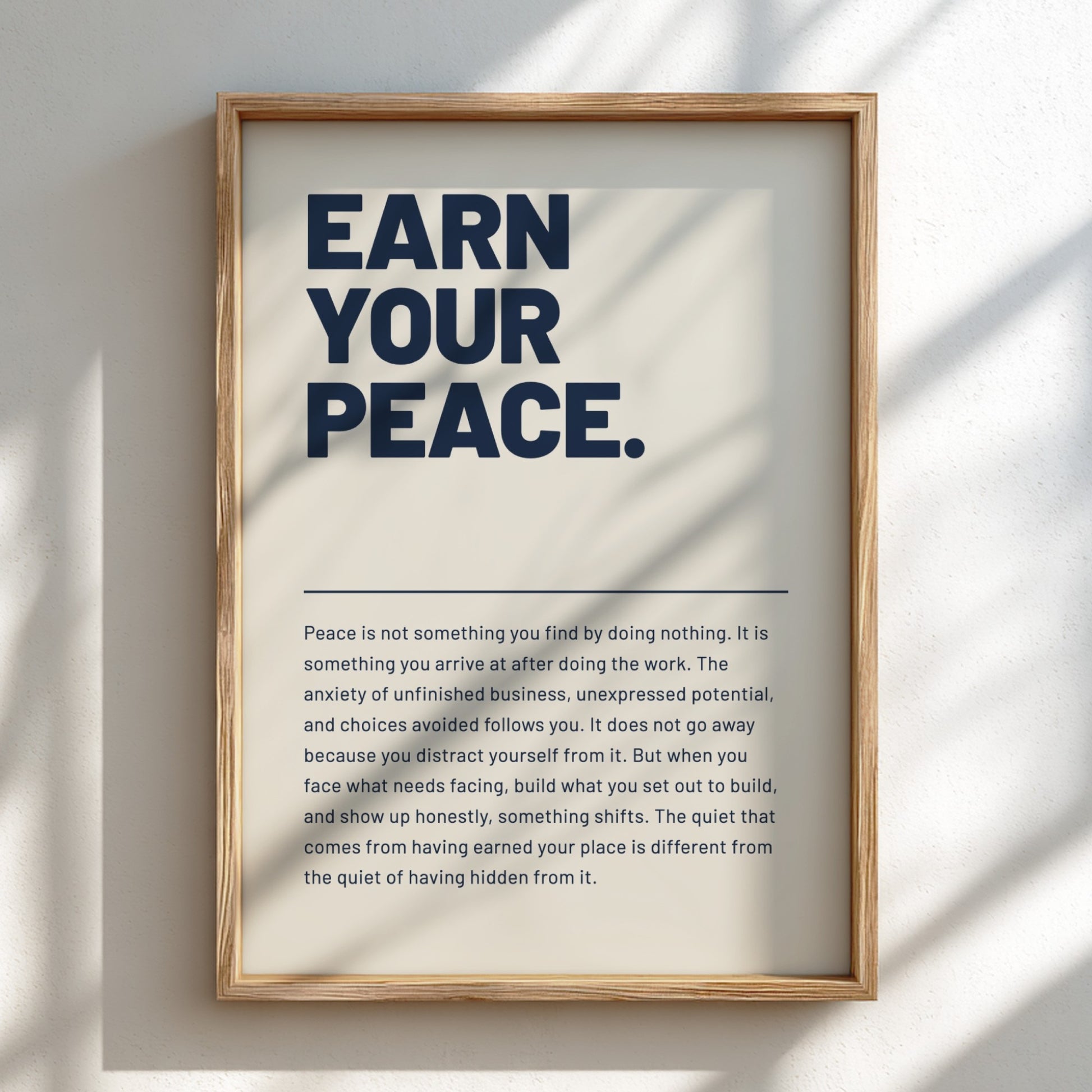 Framed poster with 'Earn Your Peace' text on a light background