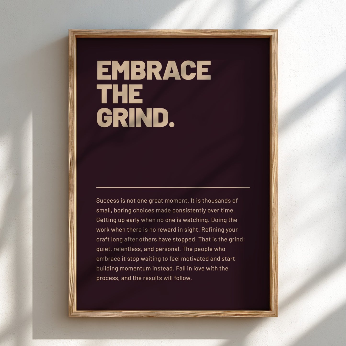 Framed motivational poster with text 'Embrace the Grind' on a dark background