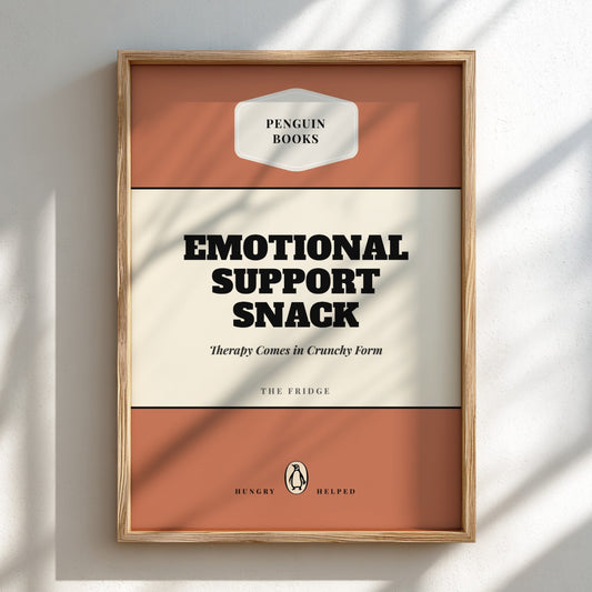 Framed artwork with 'Penguin Books' branding and text 'Emotional Support Snack'.