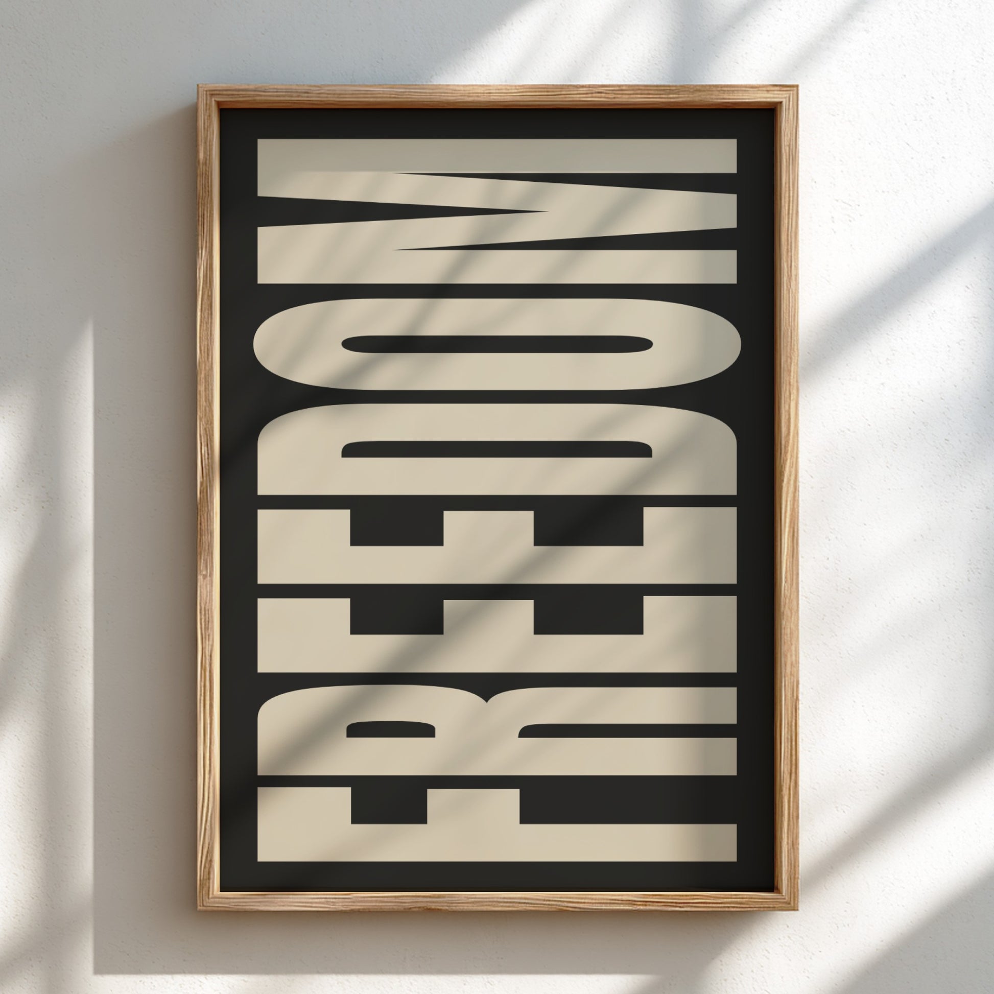 Framed artwork with stylized text on a plain wall
