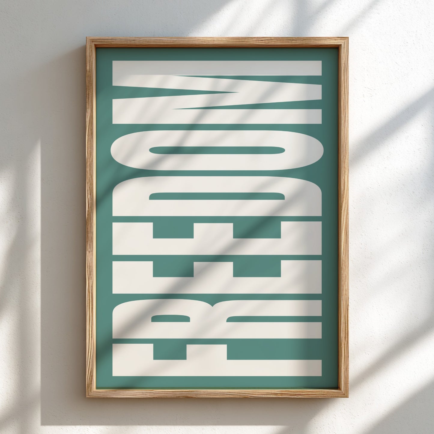 Framed artwork with the word 'FREEDOM' on a teal background