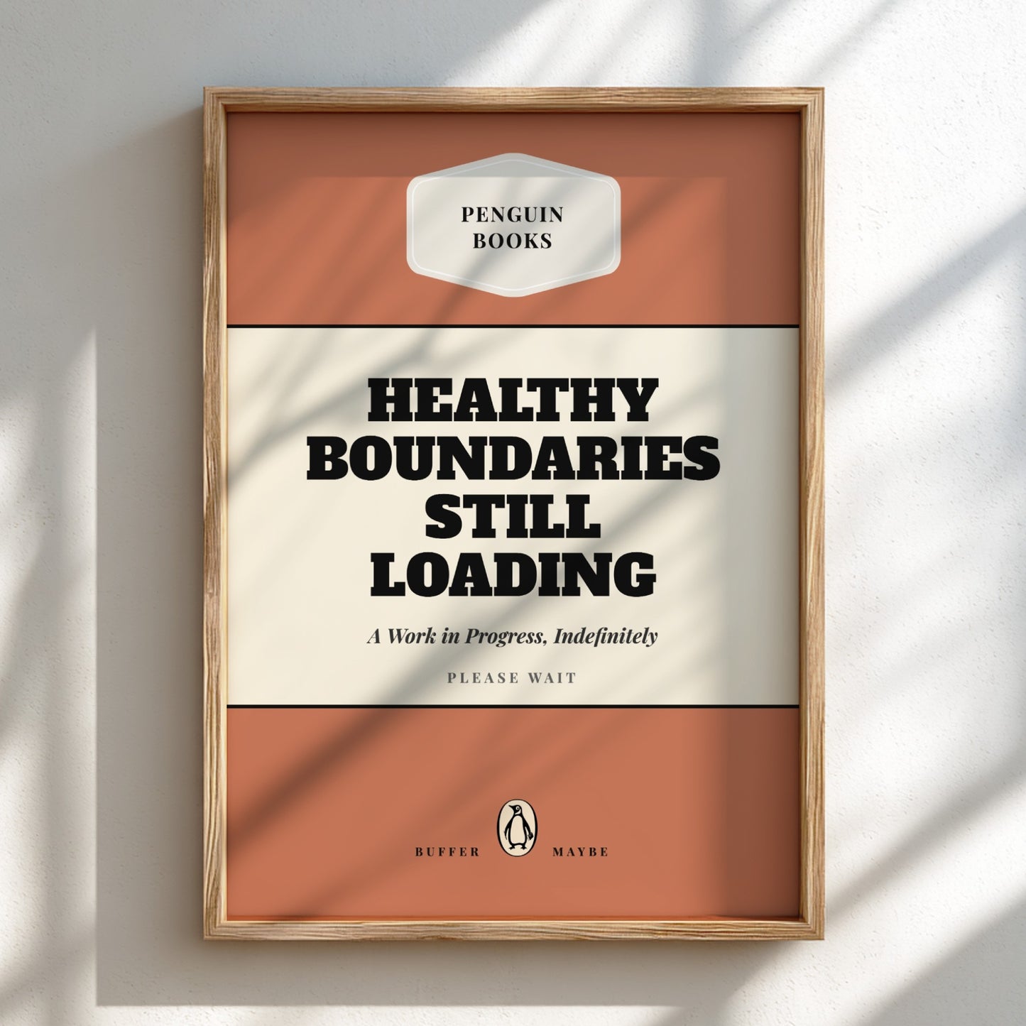 Framed poster with 'Healthy Boundaries Still Loading' text on a white wall