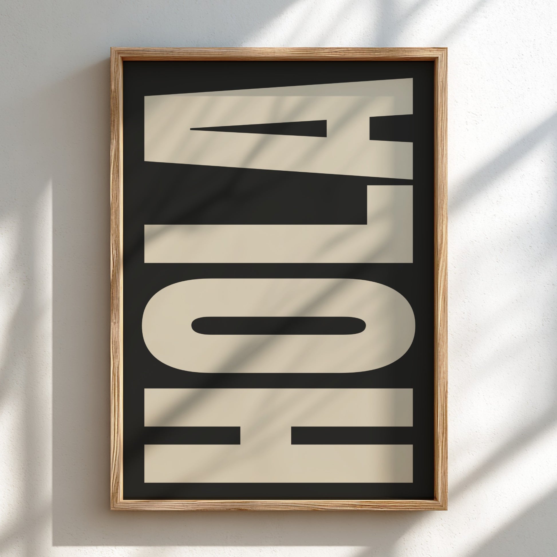 Framed artwork with the word 'HOLA' on a black background