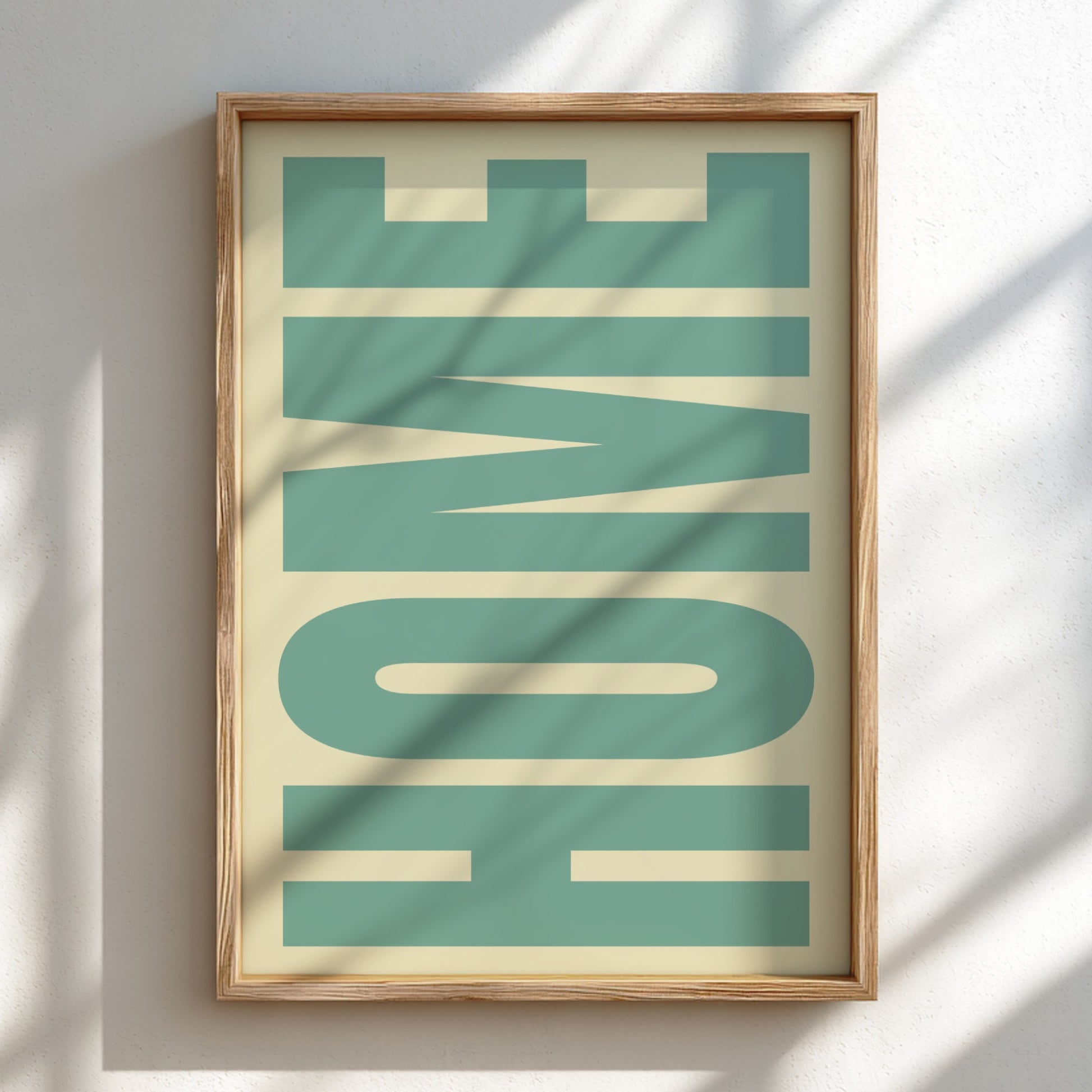 Framed artwork with the word 'HOME' in teal letters on a beige background