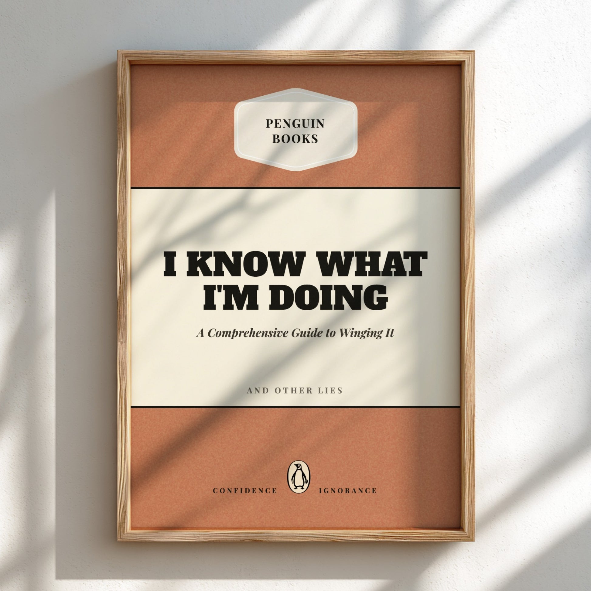 Framed book cover with 'Penguin Books' branding and humorous text on a light background