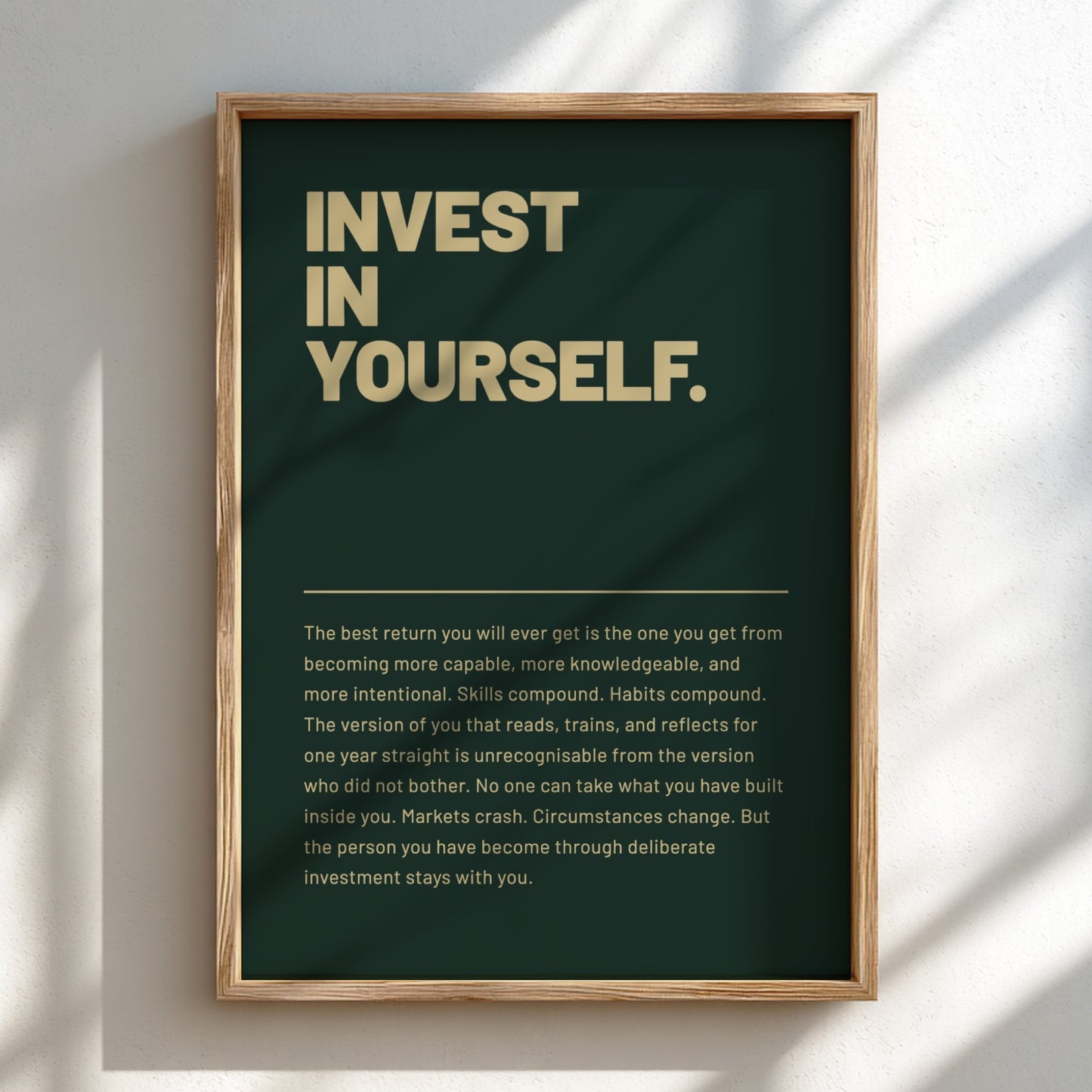 Framed motivational poster with 'Invest in Yourself' text on a dark green background.
