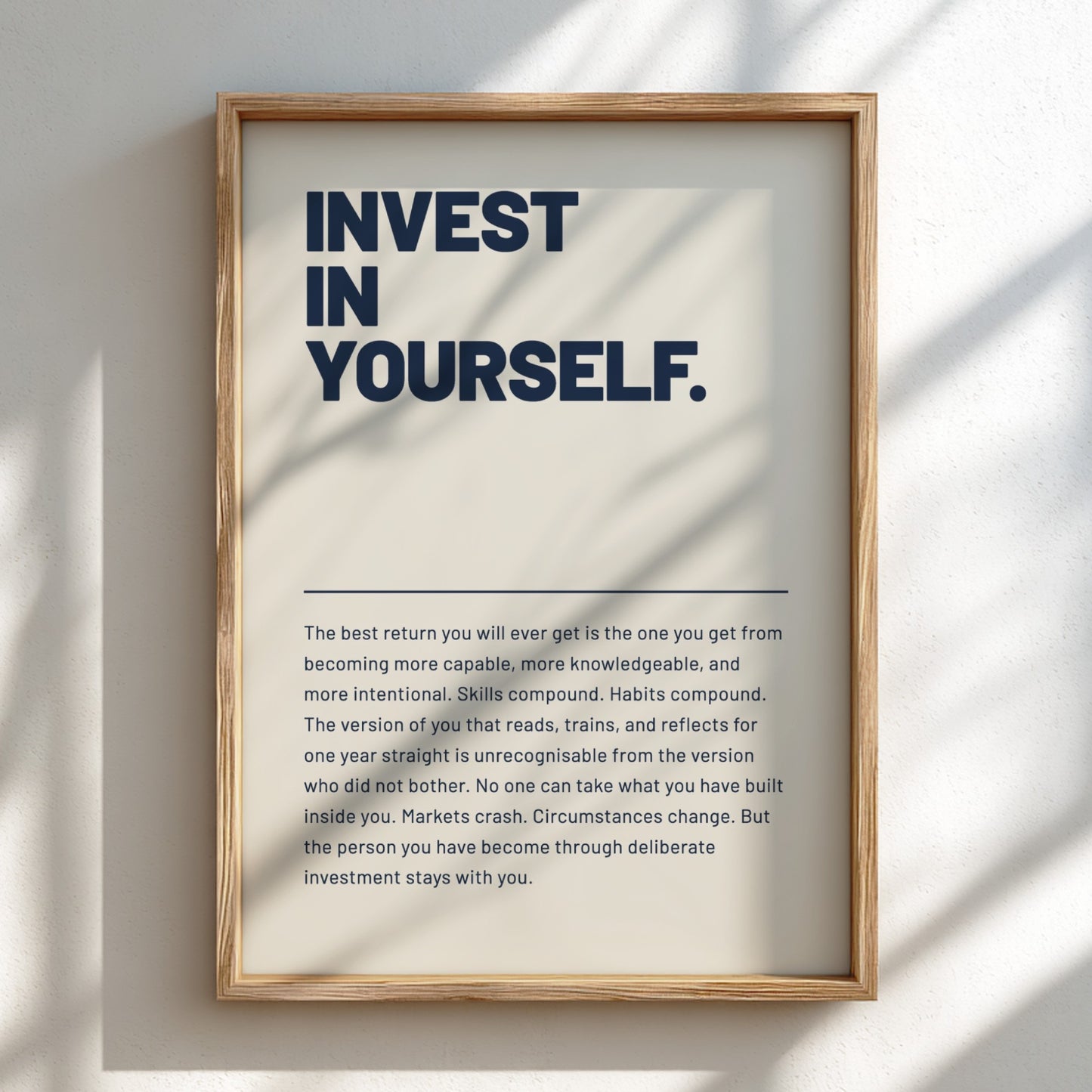 Framed motivational poster with 'Invest in Yourself' text on a light background