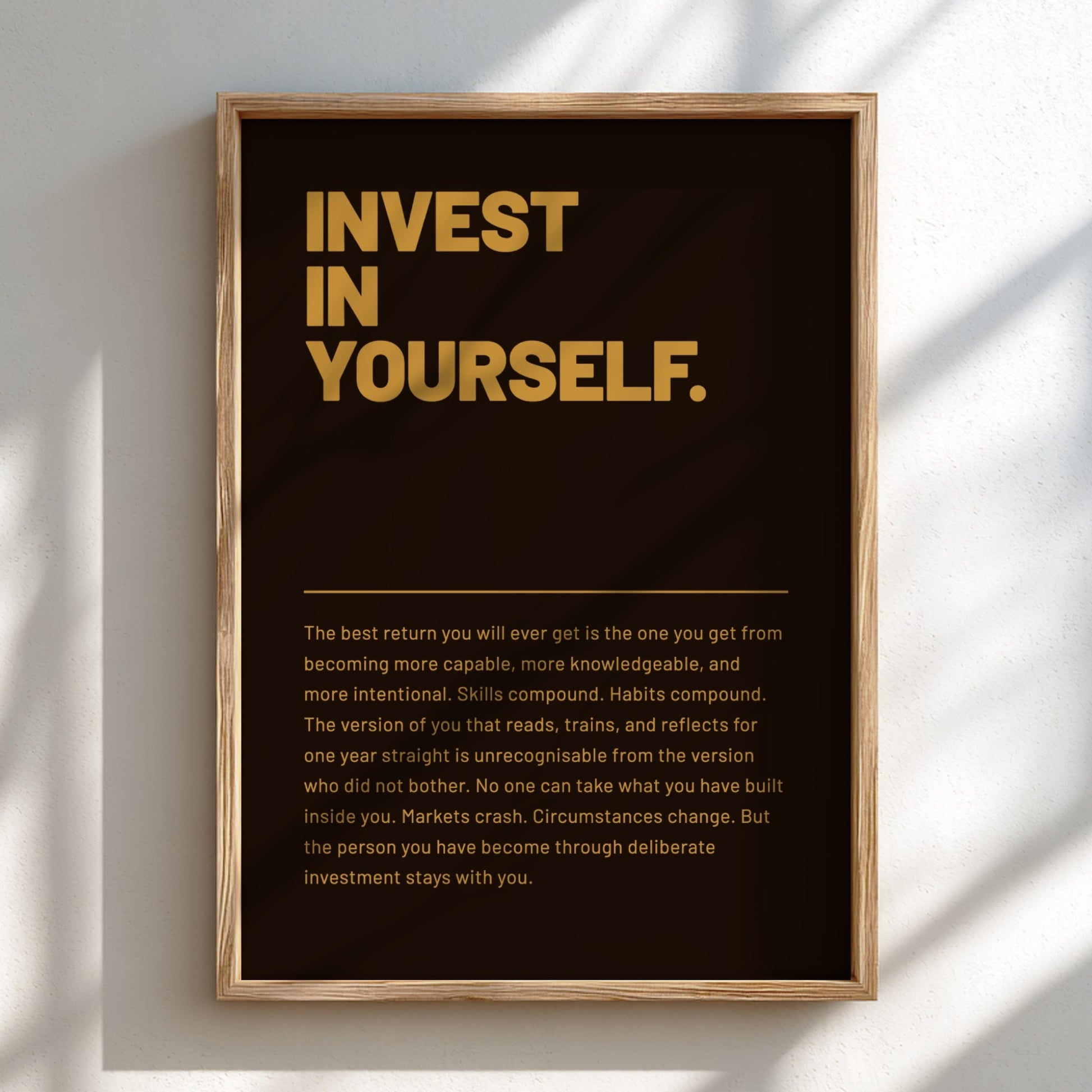 Framed motivational poster with 'Invest in Yourself' text on a dark green background.