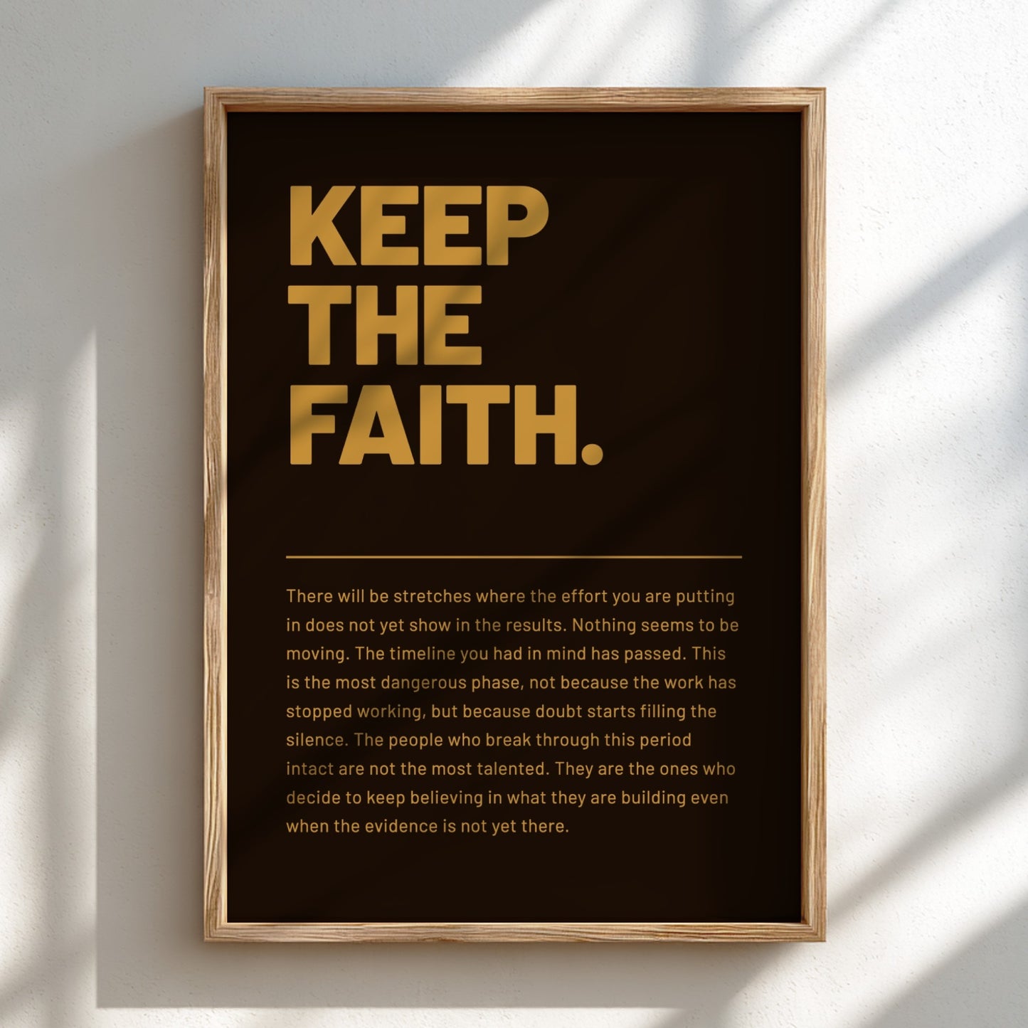 Framed poster with motivational quote 'KEEP THE FAITH.' on a dark background