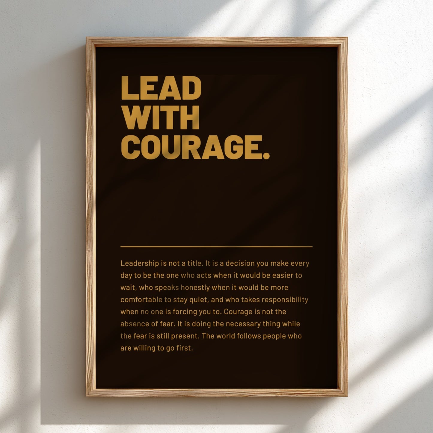 Framed poster with 'Lead with Courage' text on a dark background