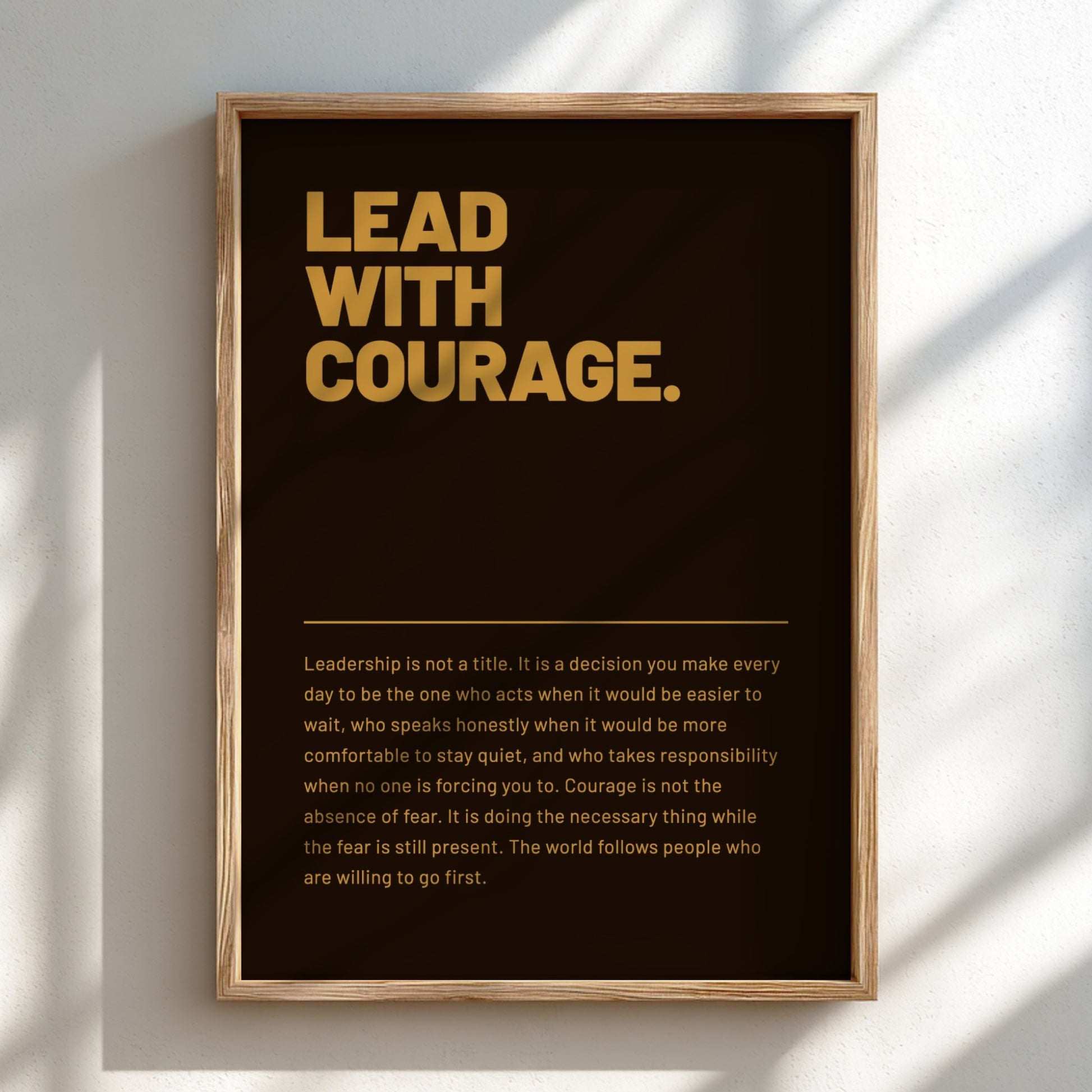 Framed poster with 'Lead with Courage' text on a dark background