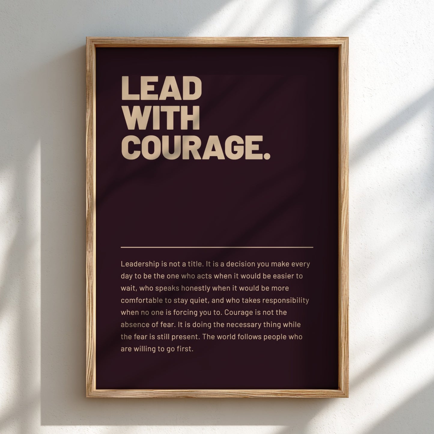 Framed poster with 'Lead with Courage' text on a dark background