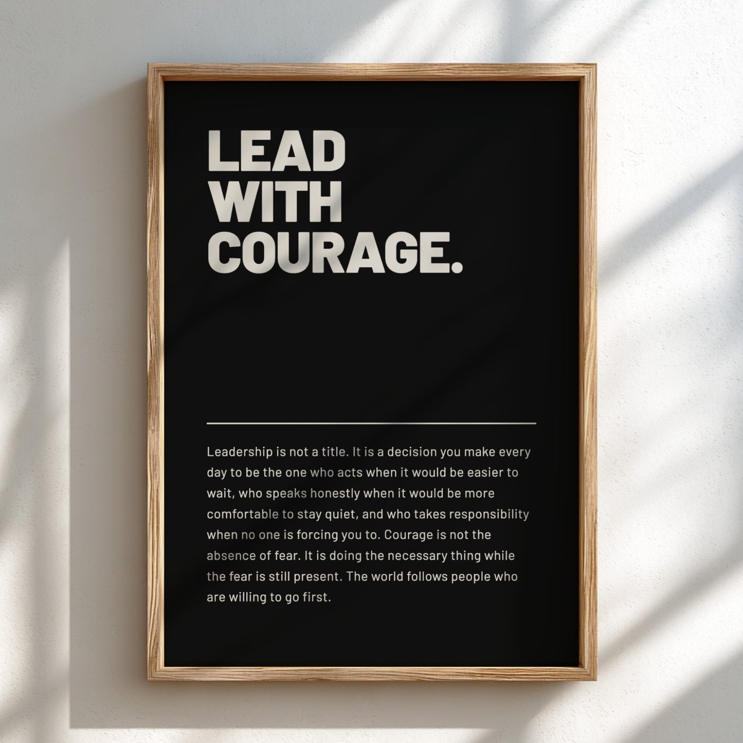 Framed poster with 'Lead with Courage' text on a black background