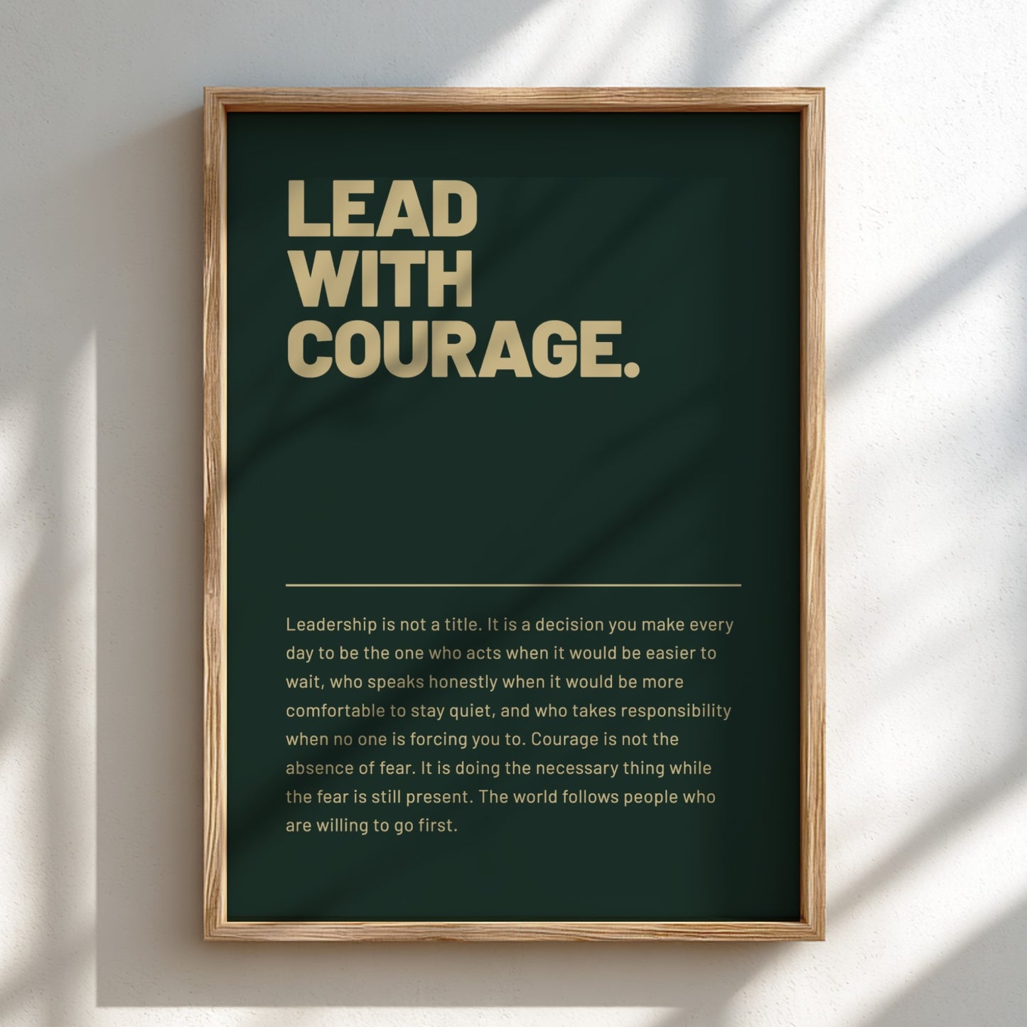 Framed poster with motivational quote 'Lead with Courage' on a dark green background