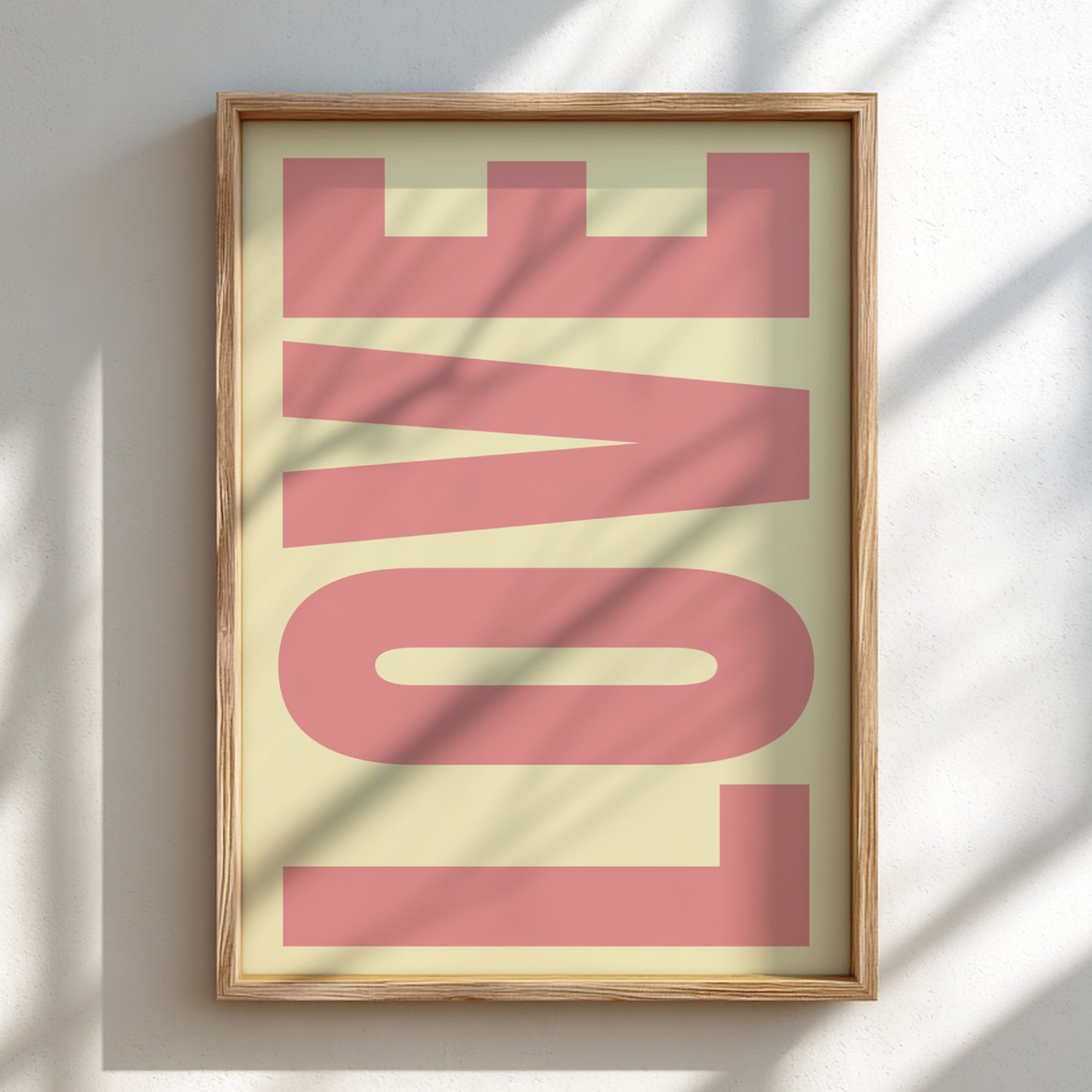 Framed artwork with the word 'LOVE' in pink on a light background