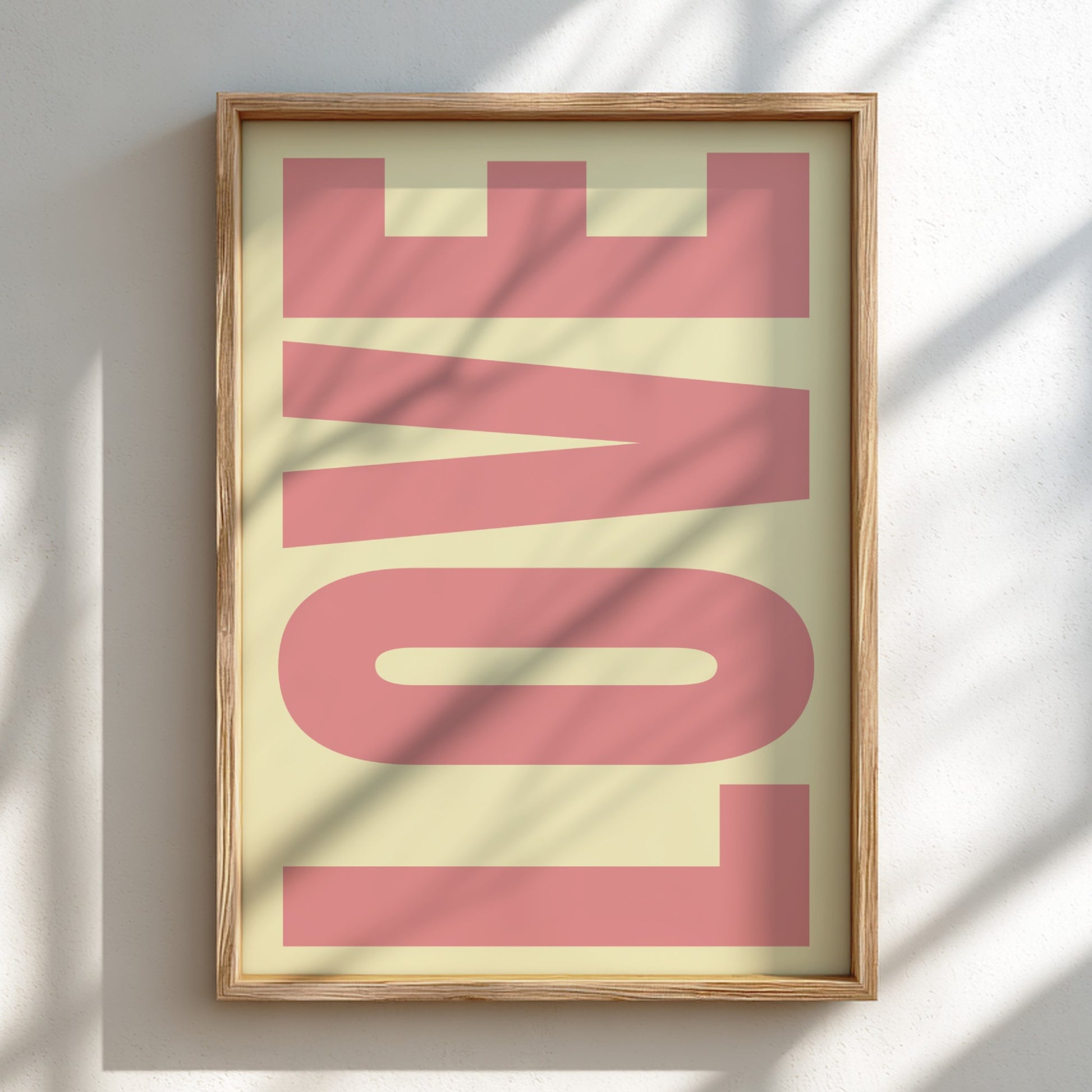 Framed artwork with the word 'LOVE' in pink on a light background