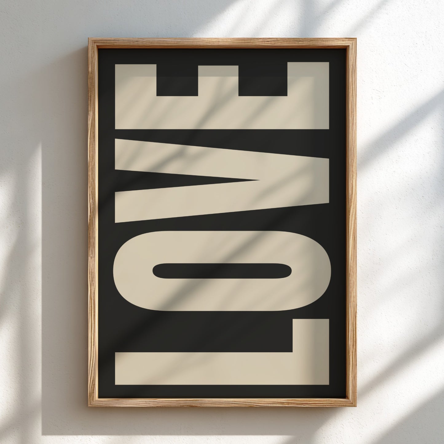 Framed artwork with the word 'LOVE' on a black background