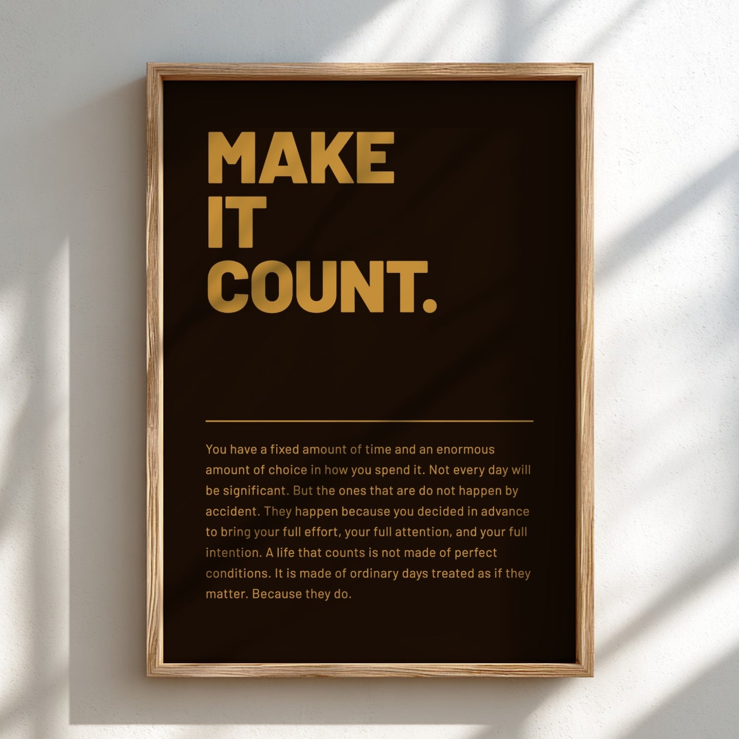 Framed poster with motivational quote 'MAKE IT COUNT.' on a dark background