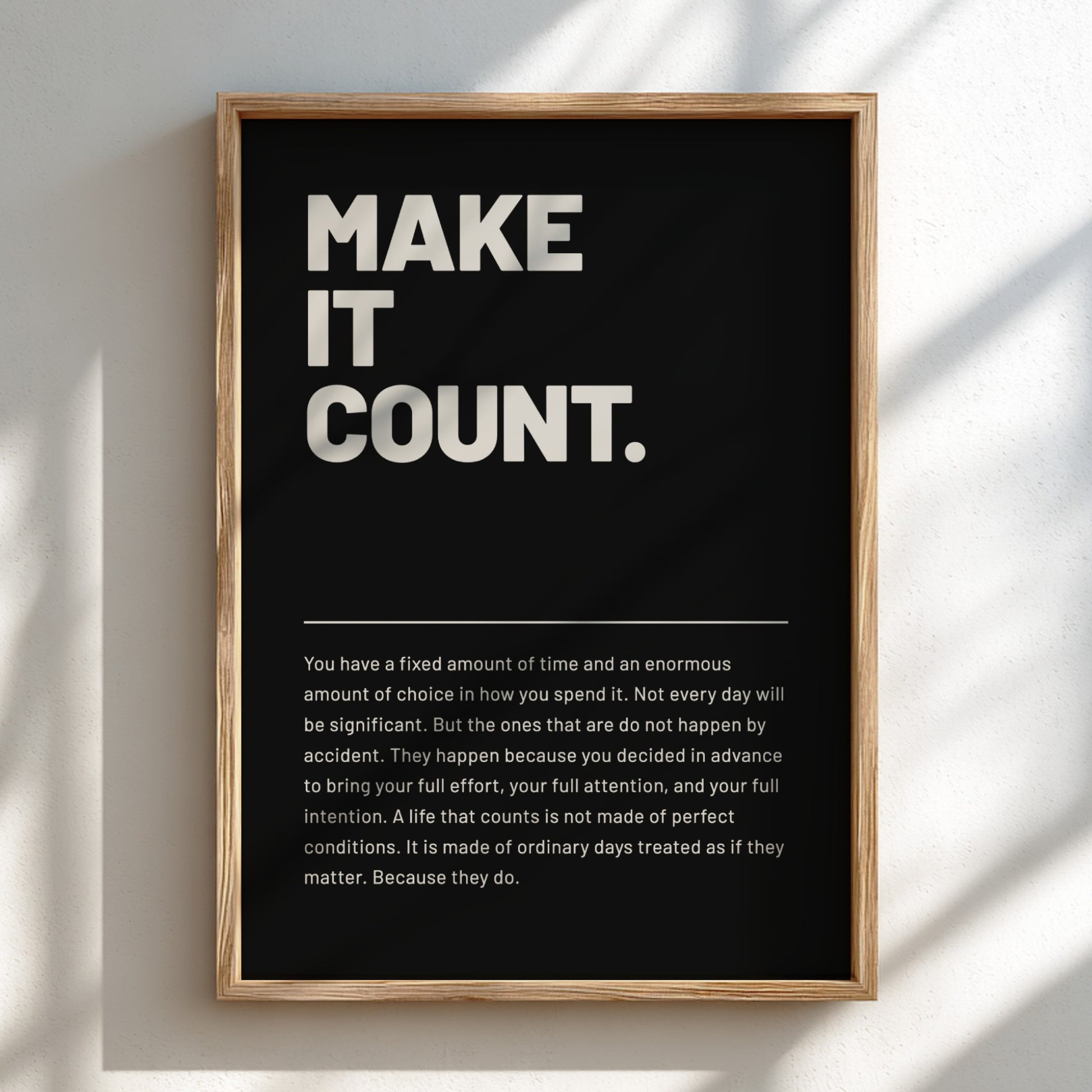 Framed poster with motivational quote 'MAKE IT COUNT.' on a black background