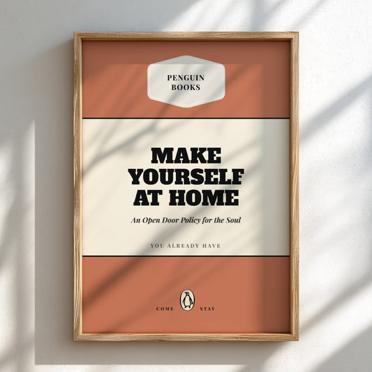 Framed Penguin Books poster with 'Make Yourself at Home' text on a white wall.