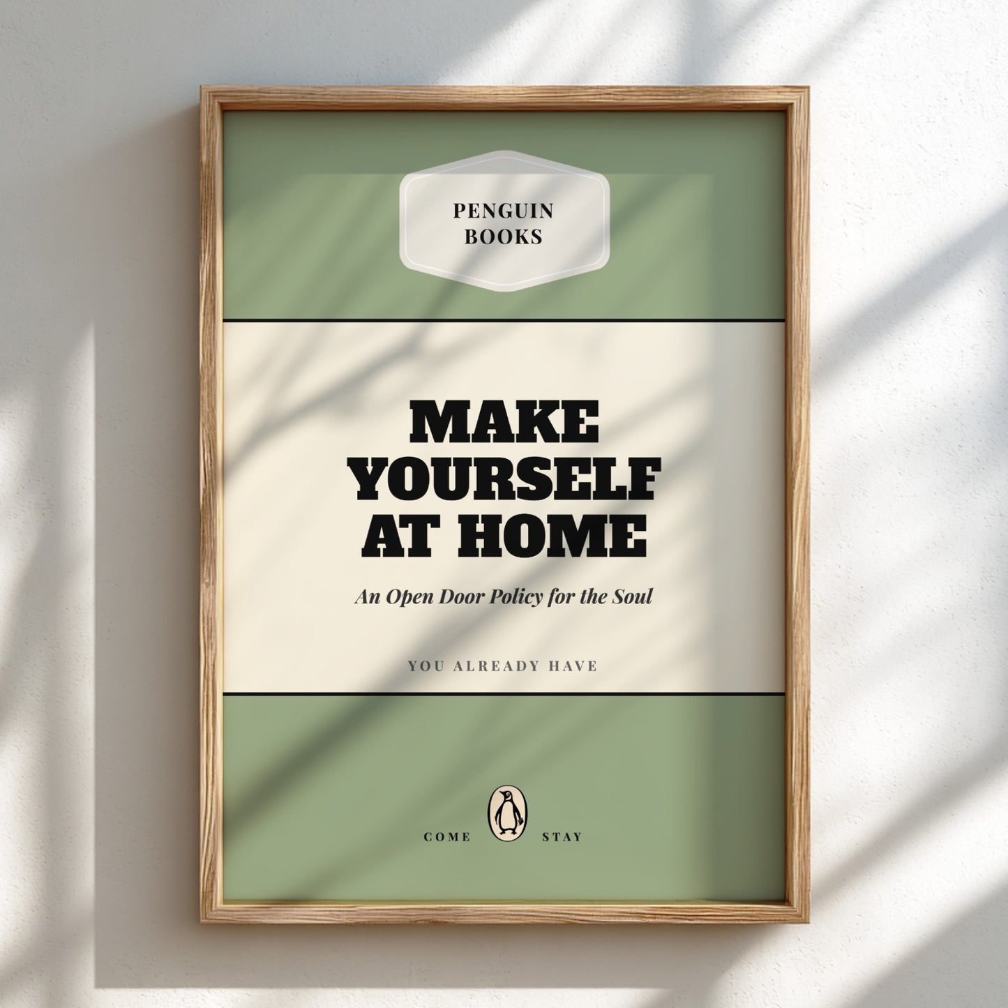 Framed Penguin Books poster with 'Make Yourself at Home' text on a light background