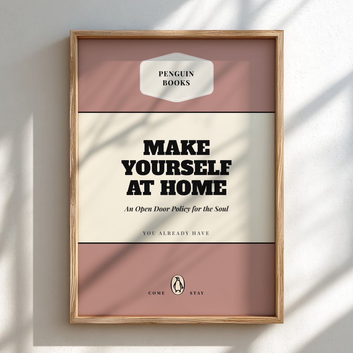 Framed Penguin Books poster with 'Make Yourself at Home' text on a light background